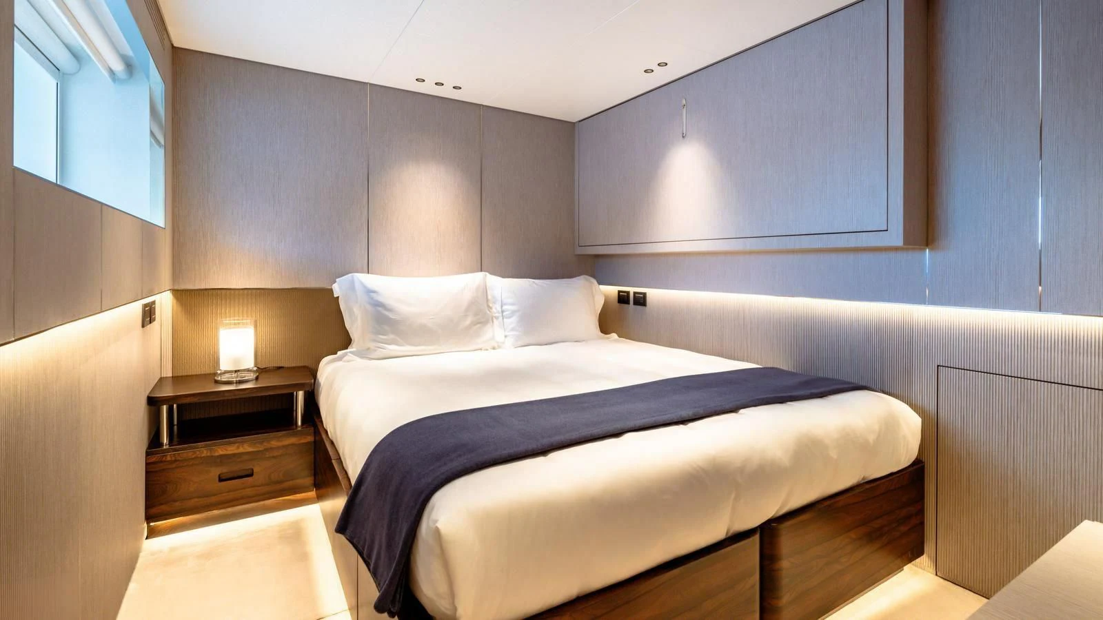 a room with a bed and a desk aboard WAVE Yacht for Sale