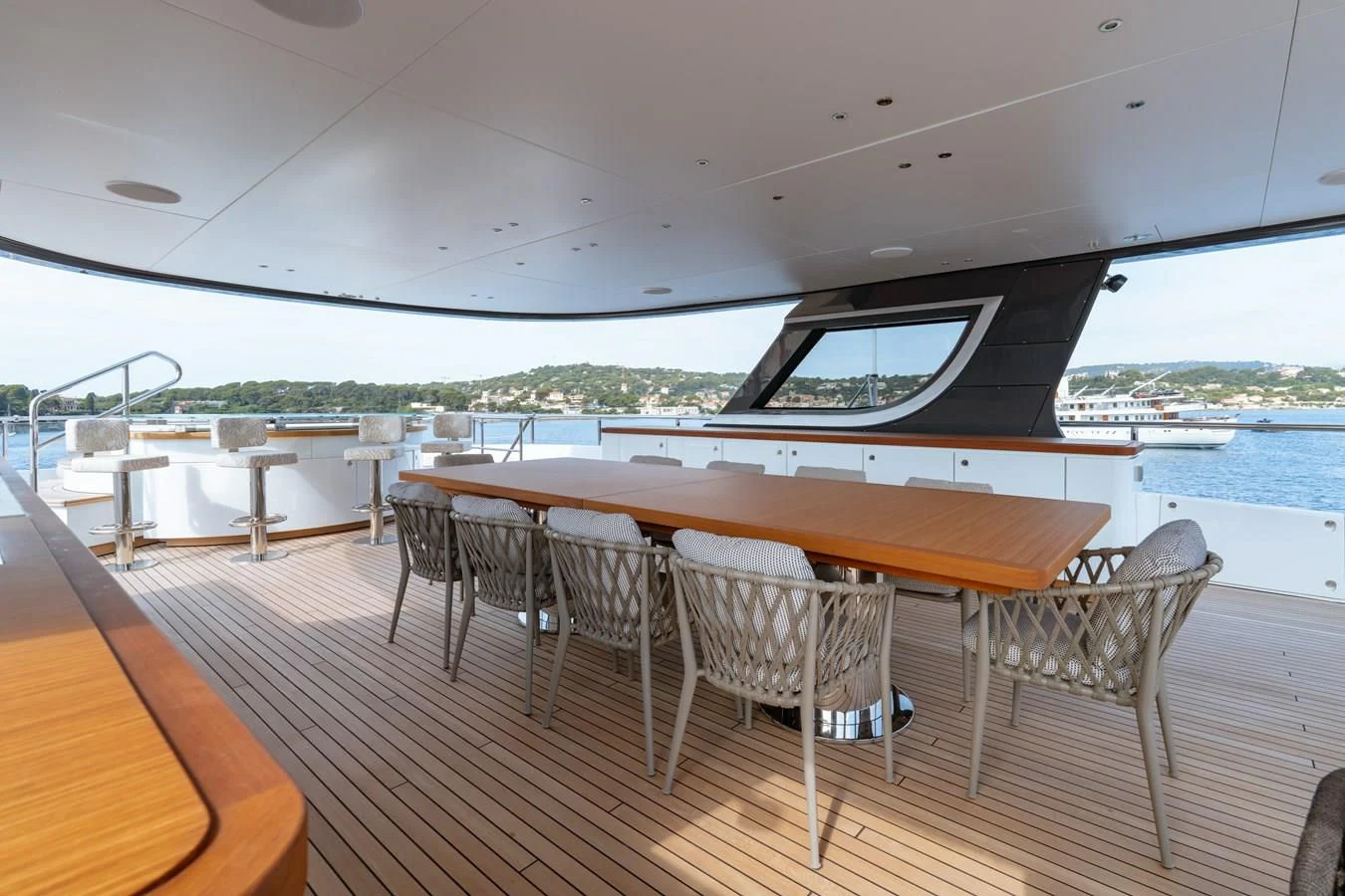 a table and chairs on a deck aboard WAVE Yacht for Sale