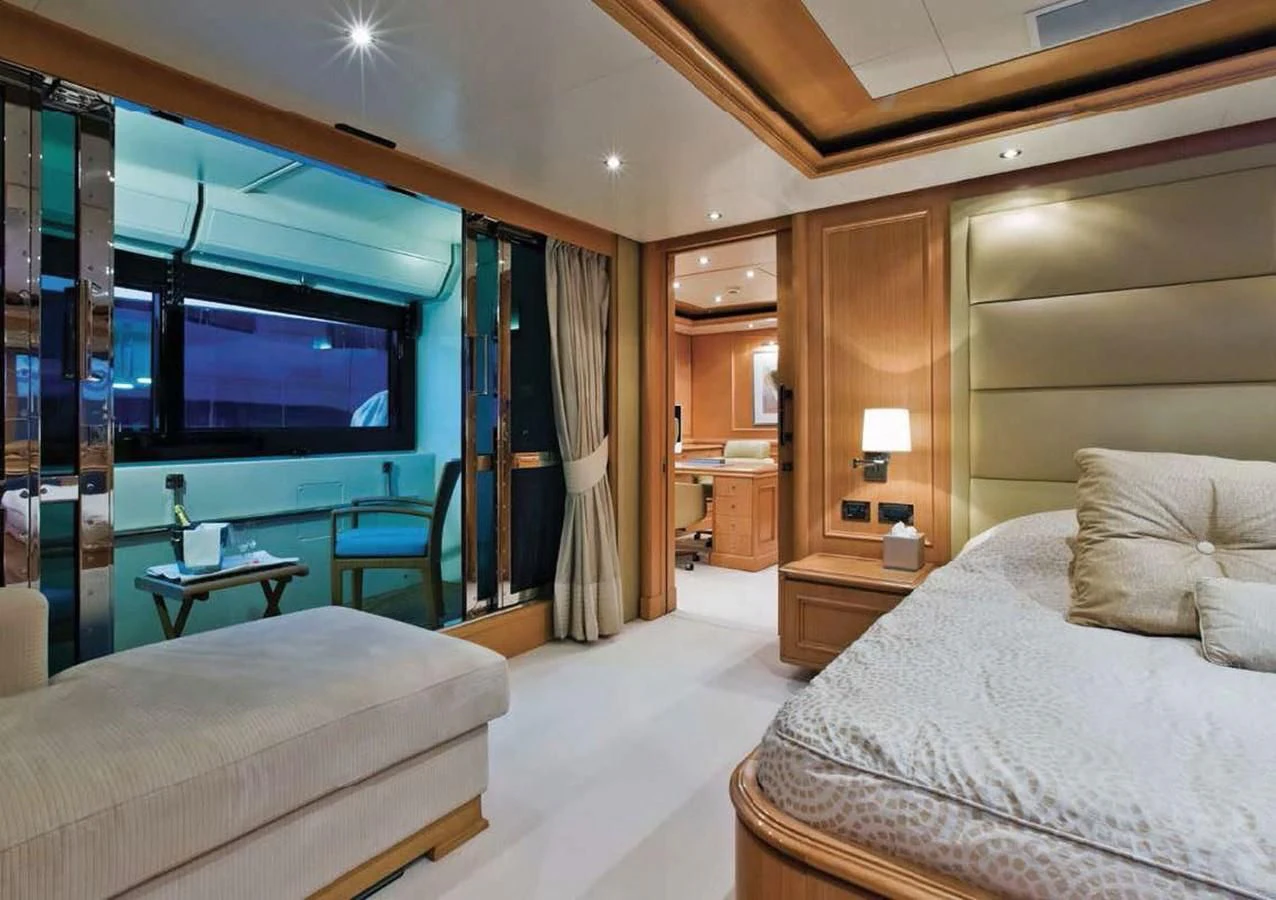 a room with a bed and a tv aboard HANA Yacht for Charter