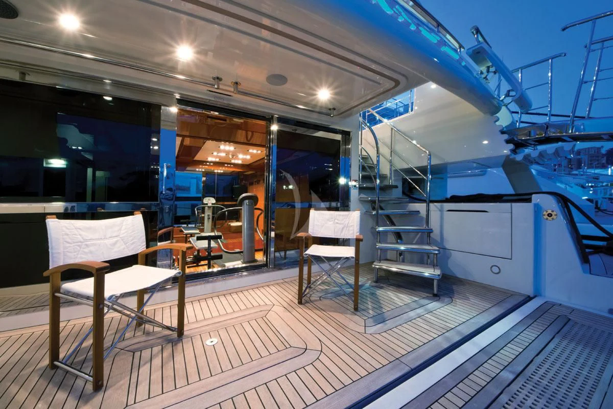 a large room with a staircase and a set of chairs aboard HANA Yacht for Charter
