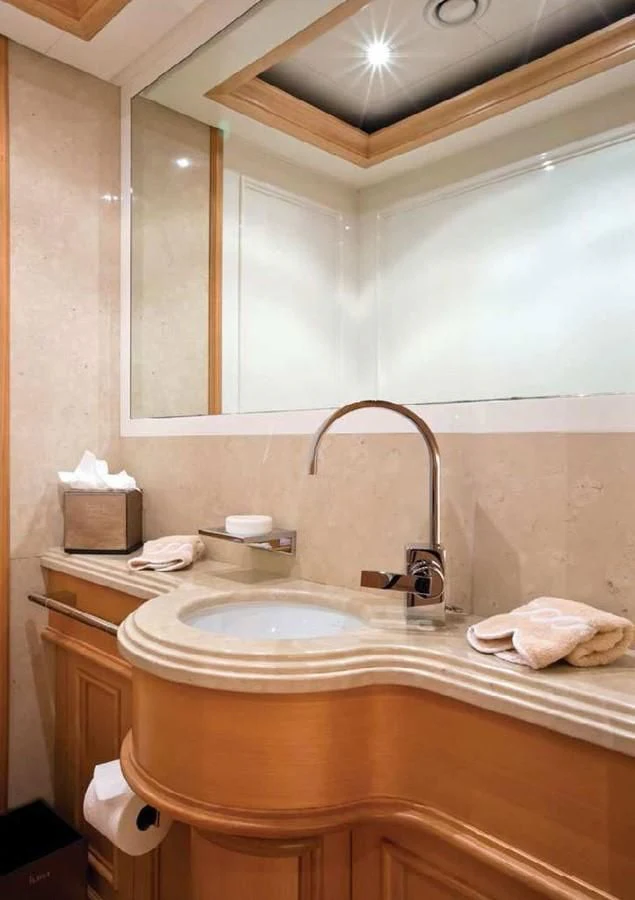 a bathroom with a sink and a mirror aboard HANA Yacht for Charter