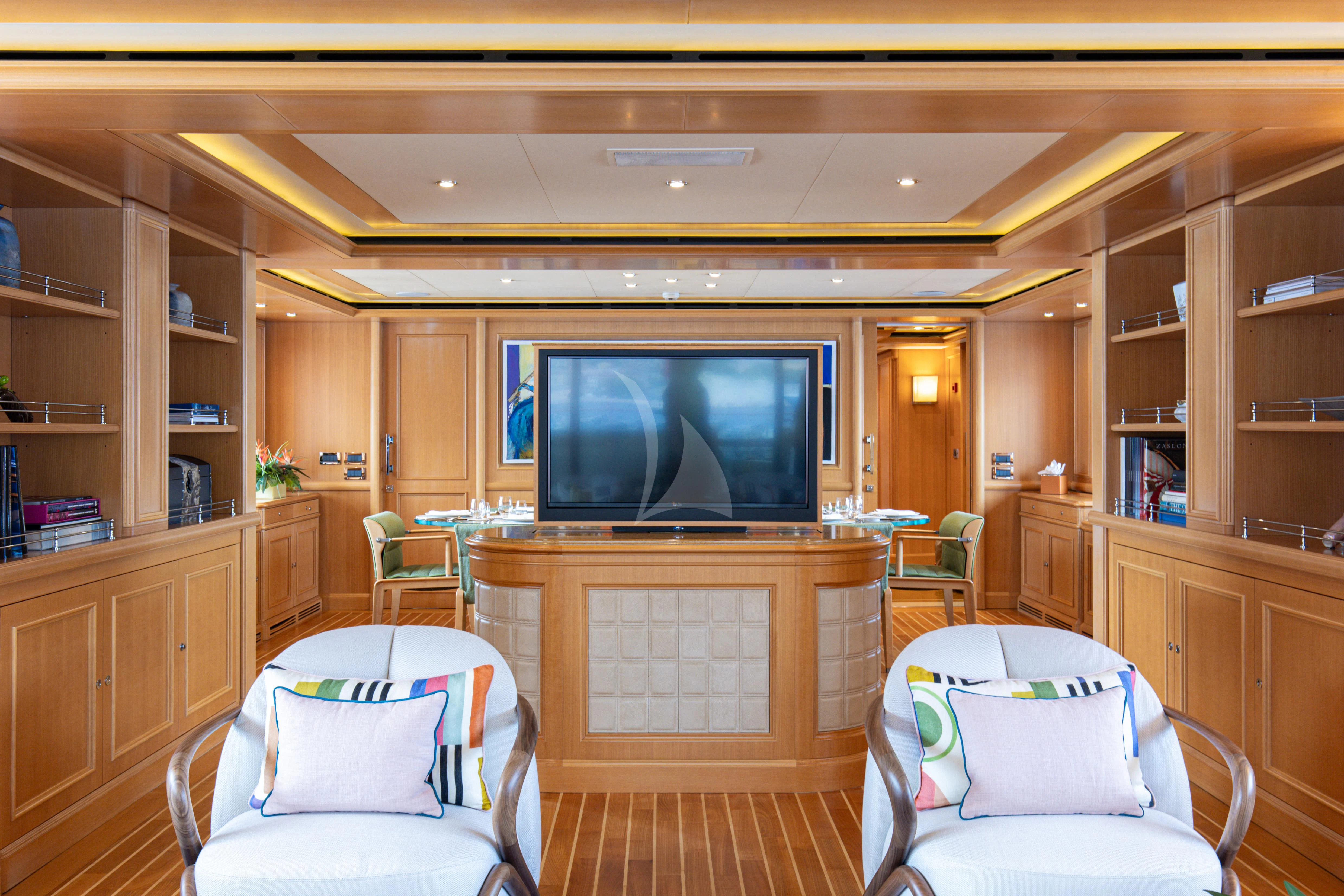 a living room with a tv aboard HANA Yacht for Charter