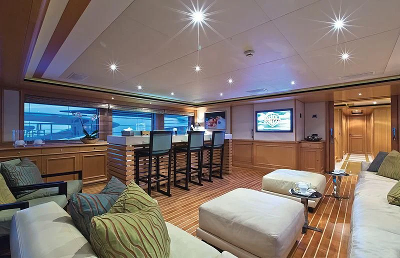a living room with a large window aboard HANA Yacht for Charter
