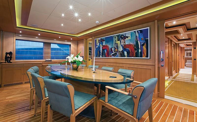 a room with a table and chairs aboard HANA Yacht for Charter