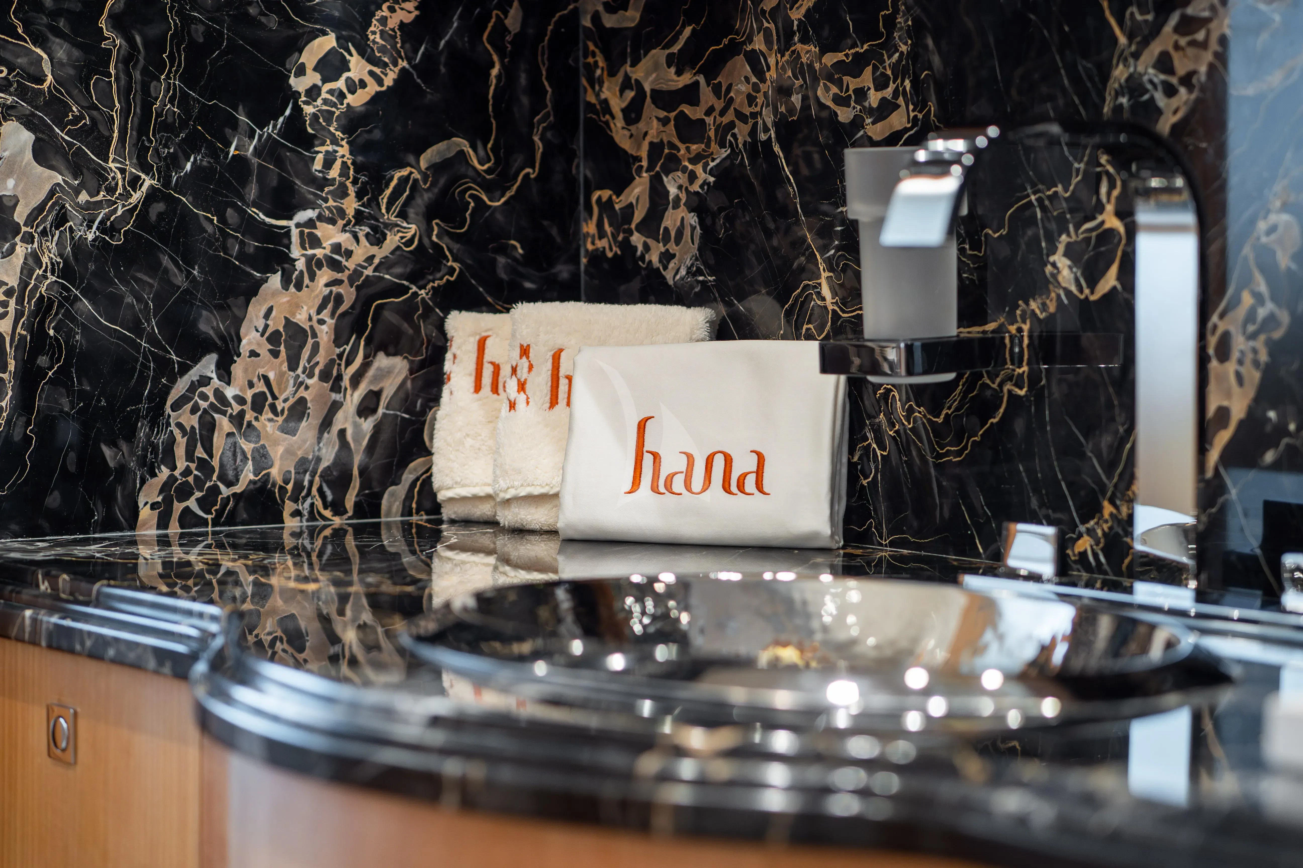 a sign on a table aboard HANA Yacht for Charter