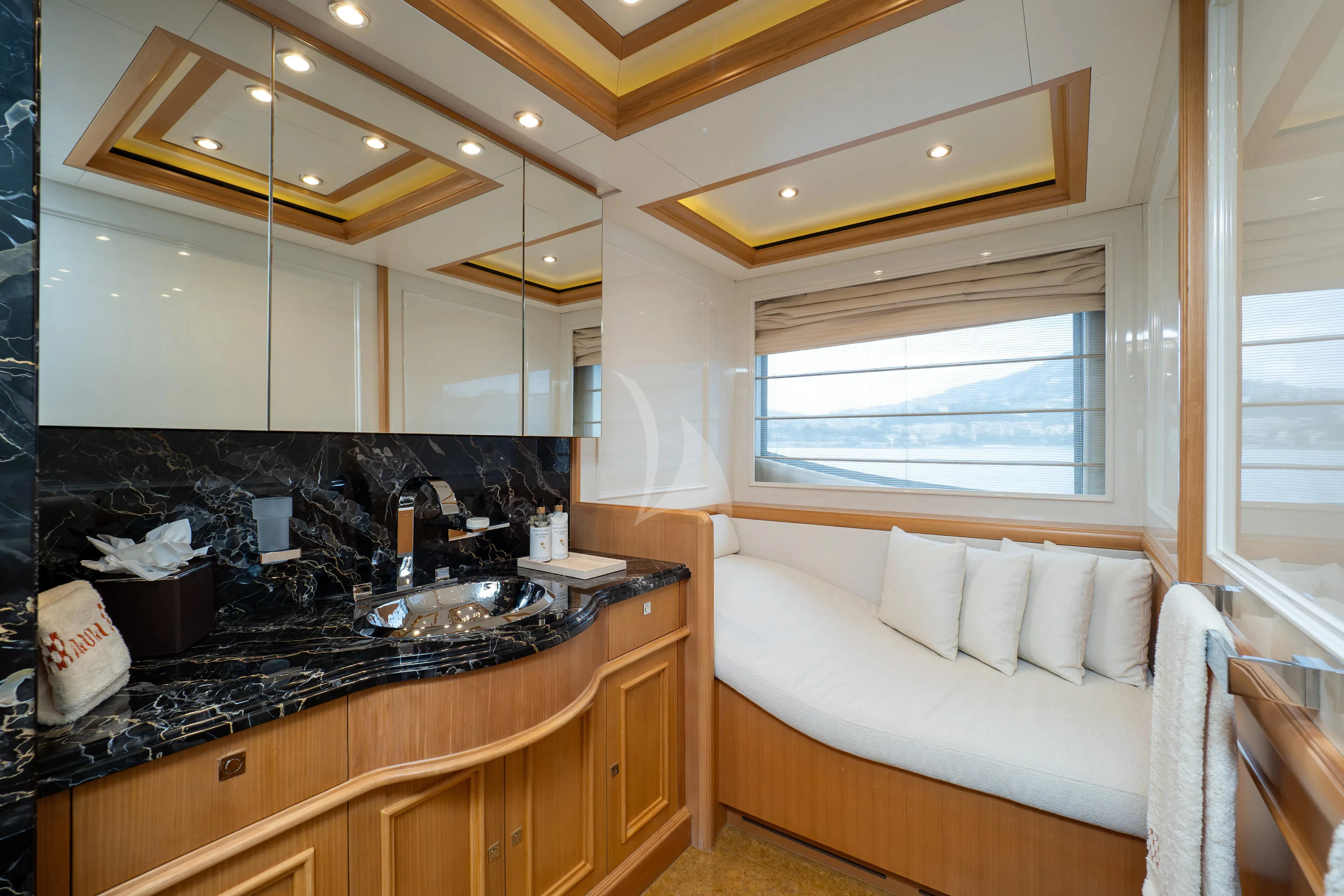 a kitchen with a sink and a bed aboard HANA Yacht for Charter