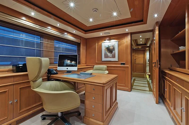 a room with a desk and a chair aboard HANA Yacht for Charter