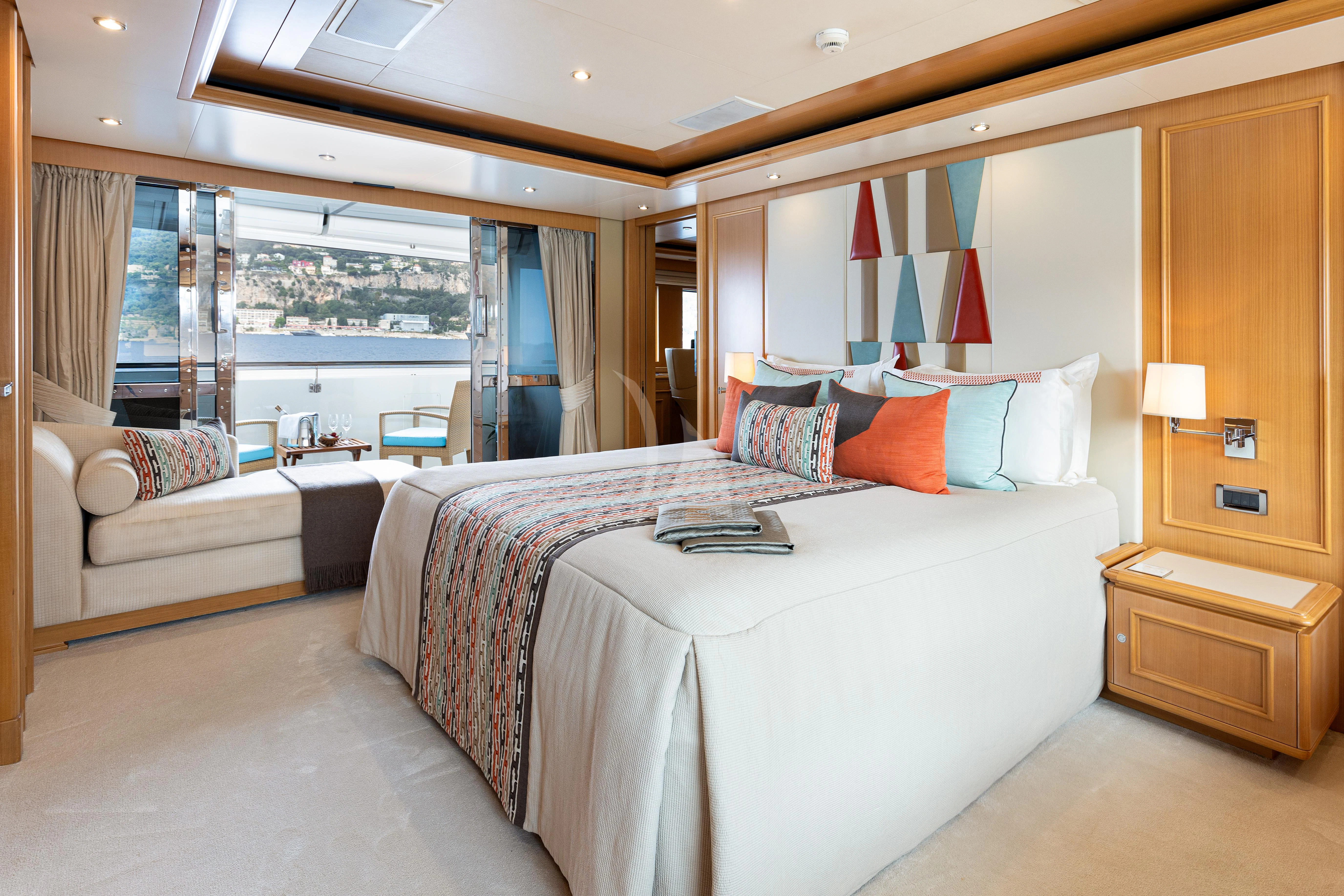 a bedroom with a bed and a desk aboard HANA Yacht for Charter