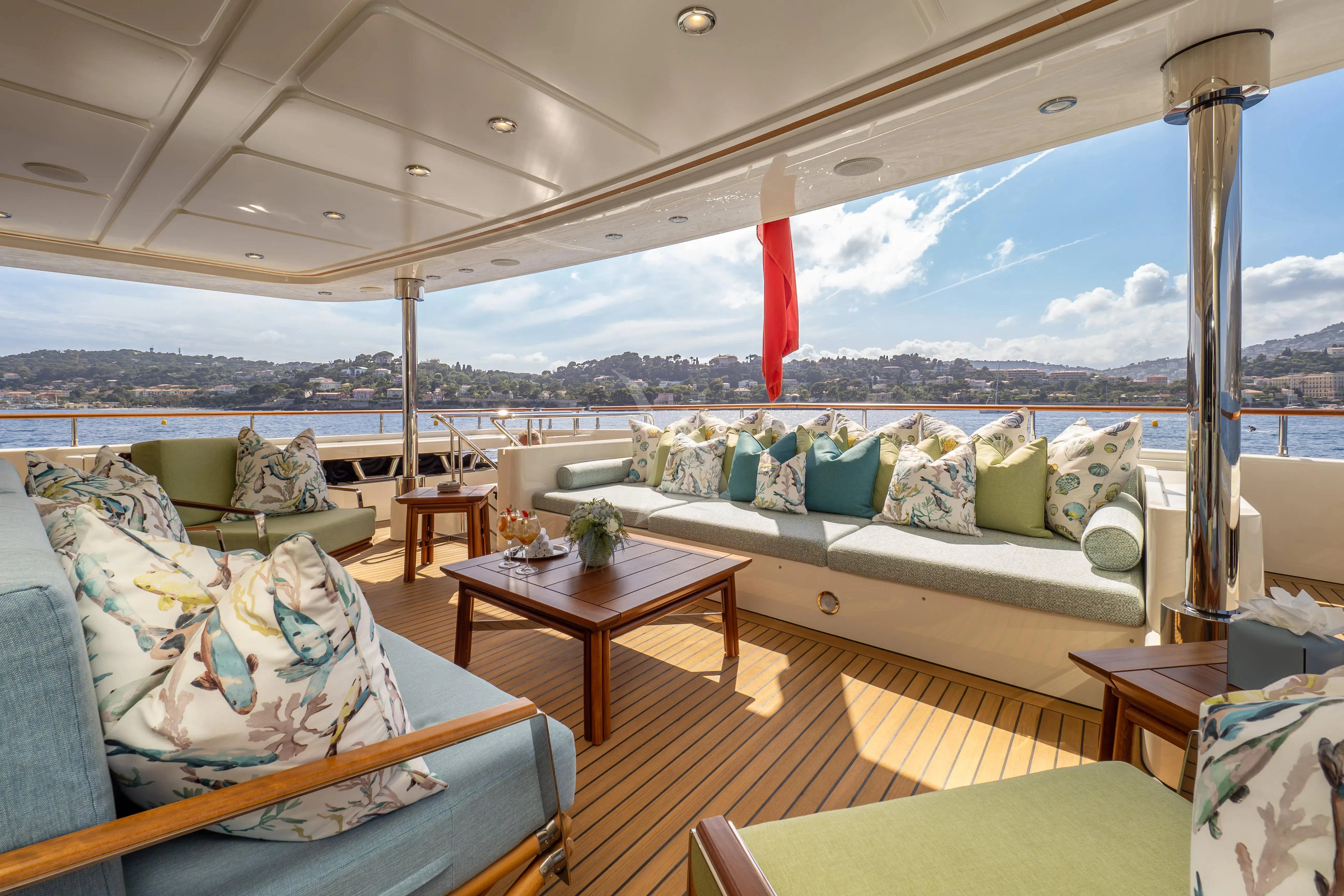 a room with a couch and a table and a window aboard HANA Yacht for Charter