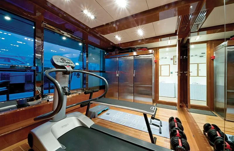a gym with a bench aboard HANA Yacht for Charter