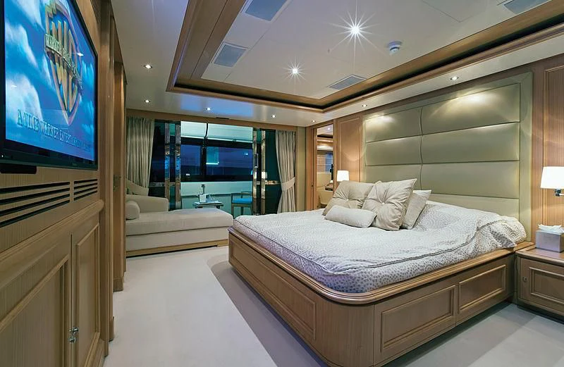 a hotel room with a bed and a tv aboard HANA Yacht for Charter