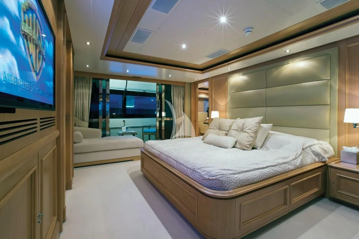 a hotel room with a large bed aboard HANA Yacht for Charter