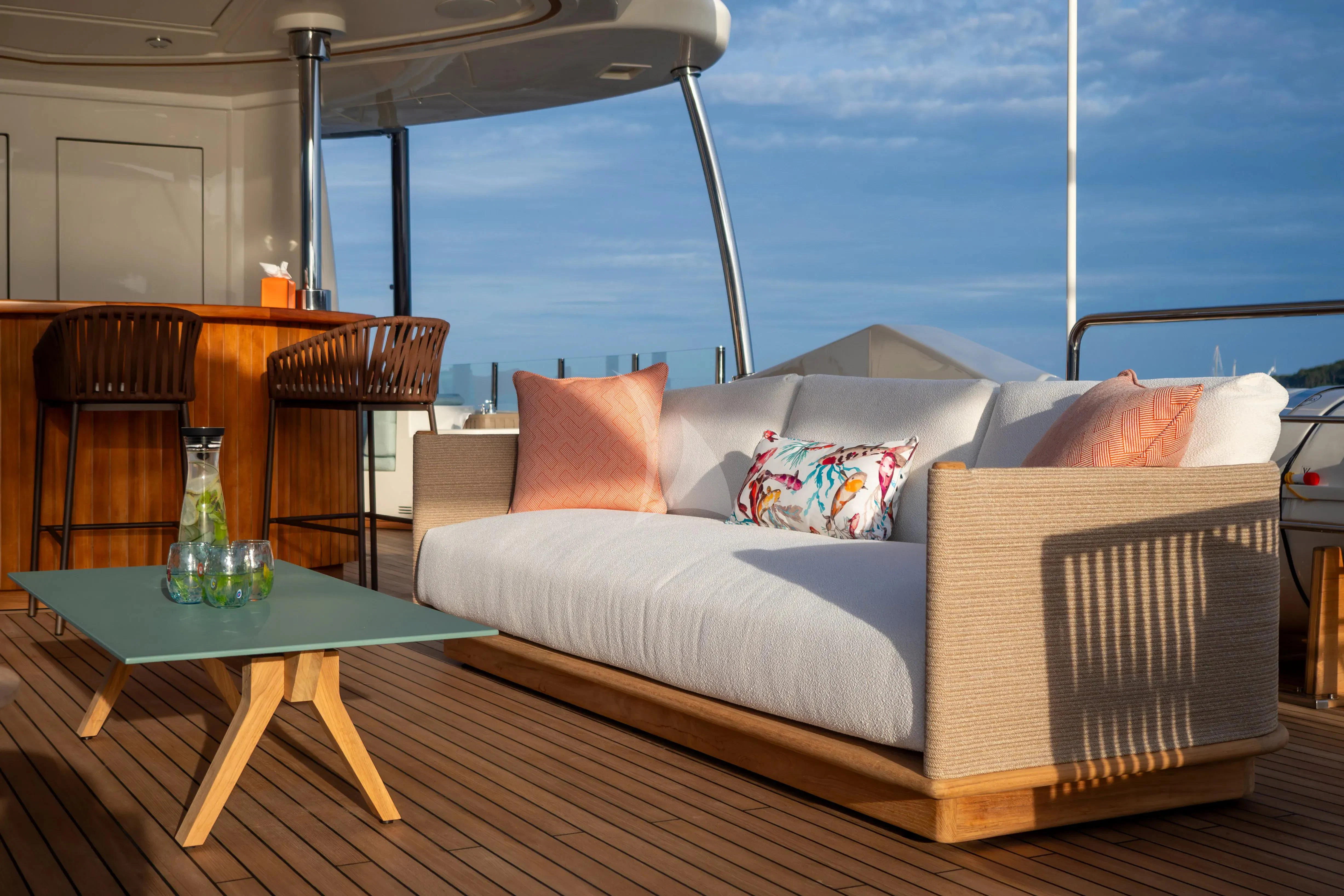 a couch and a table in a room aboard HANA Yacht for Charter