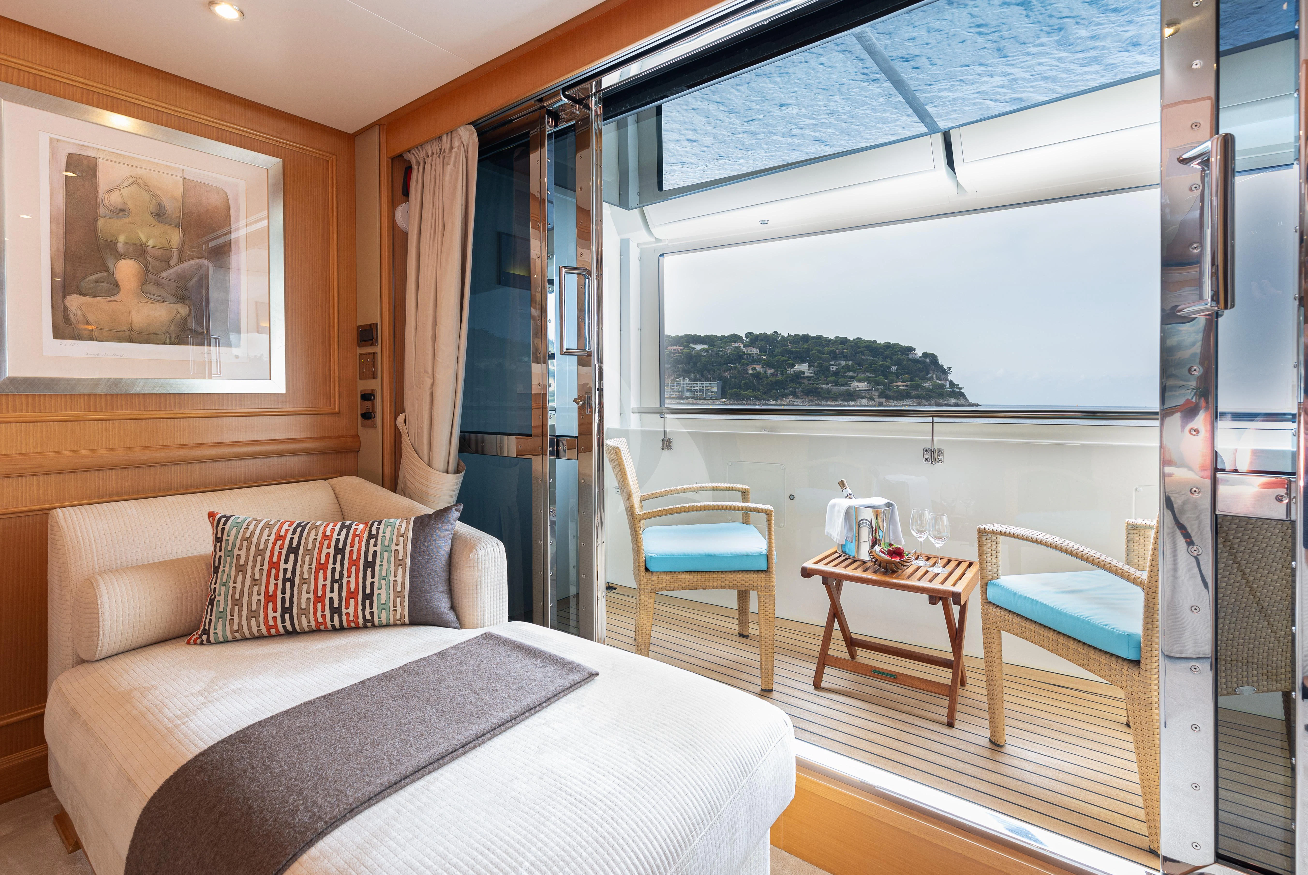 a room with a bed and a table aboard HANA Yacht for Charter