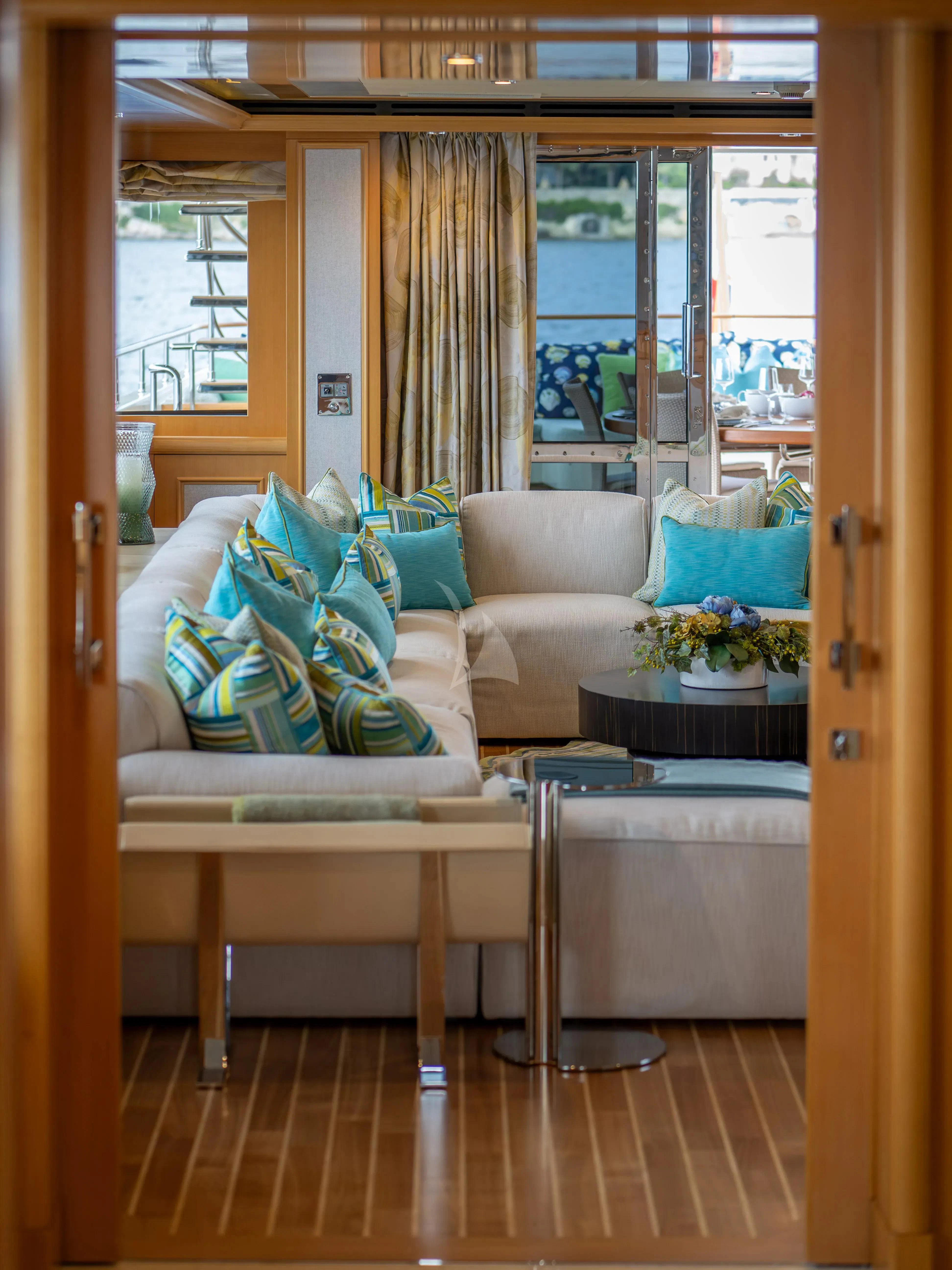 a living room with a couch and a table aboard HANA Yacht for Charter