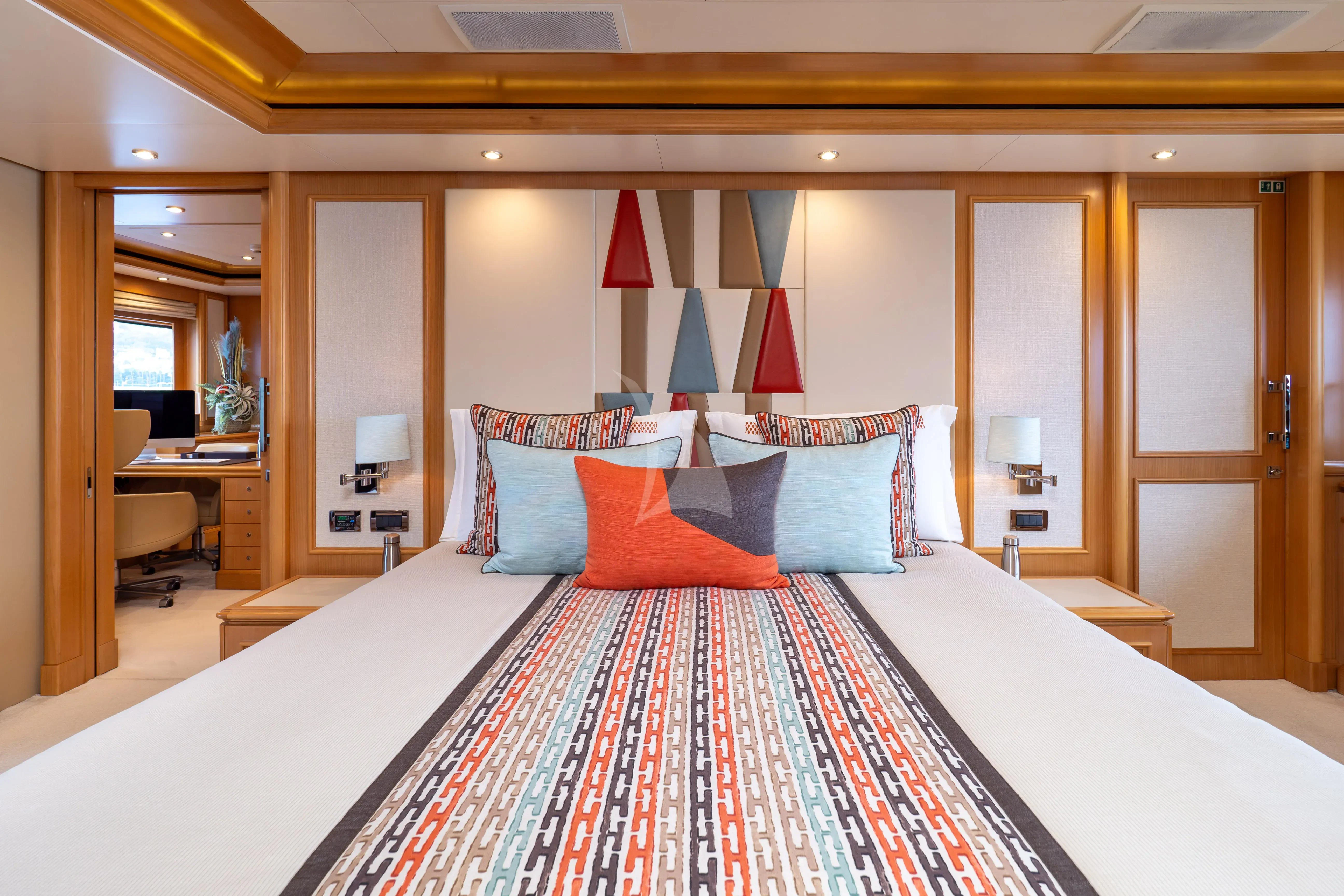a bed with a red and white checkered blanket aboard HANA Yacht for Charter