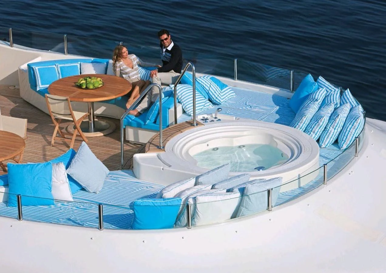 a couple sitting at a table aboard HANA Yacht for Charter