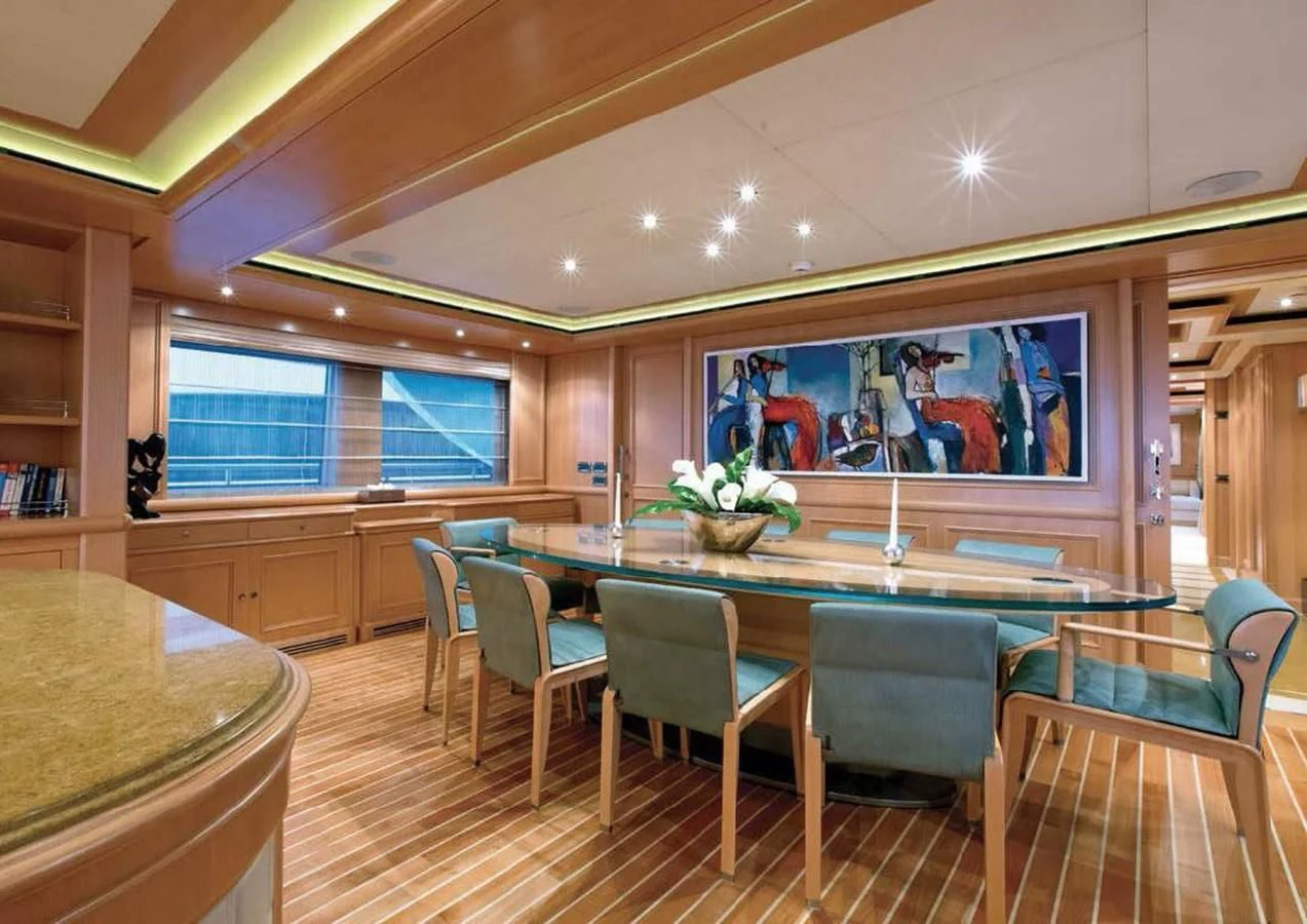 a large room with a table and chairs aboard HANA Yacht for Charter
