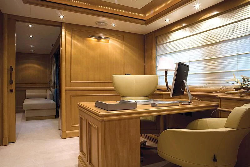 a room with a desk and a chair aboard HANA Yacht for Charter