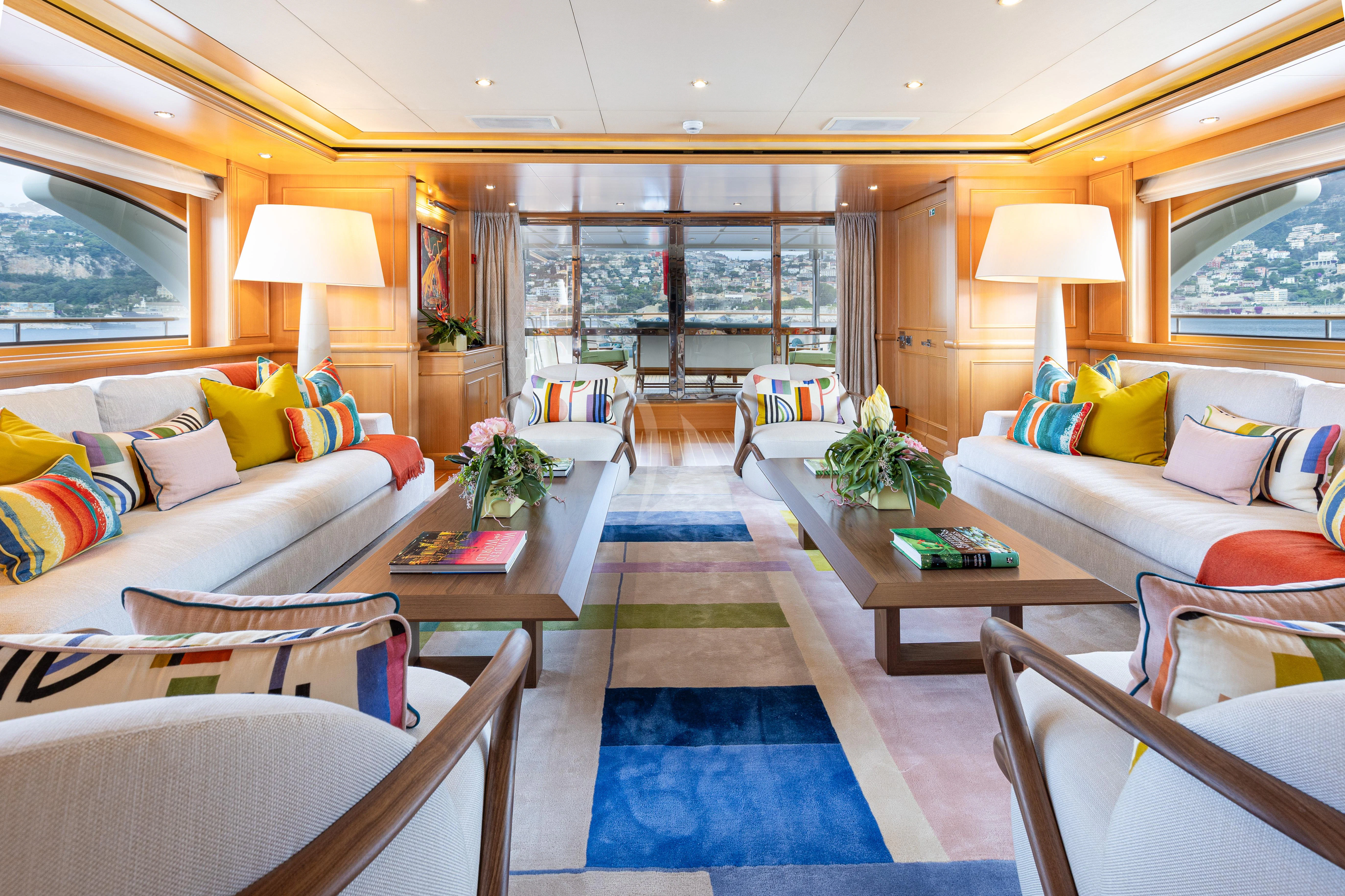 a living room with a blue rug aboard HANA Yacht for Charter