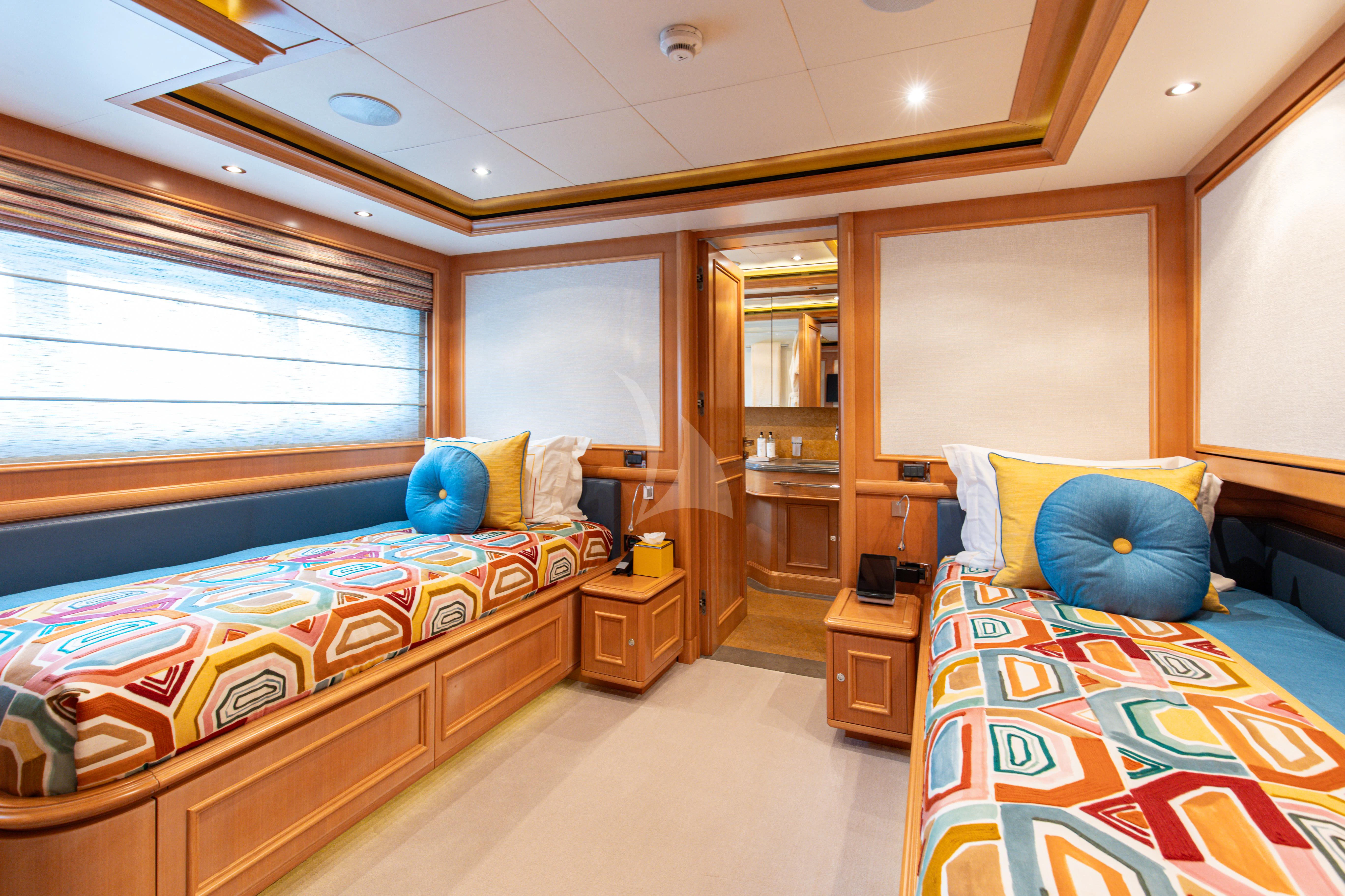 a bedroom with a bed and a desk aboard HANA Yacht for Charter