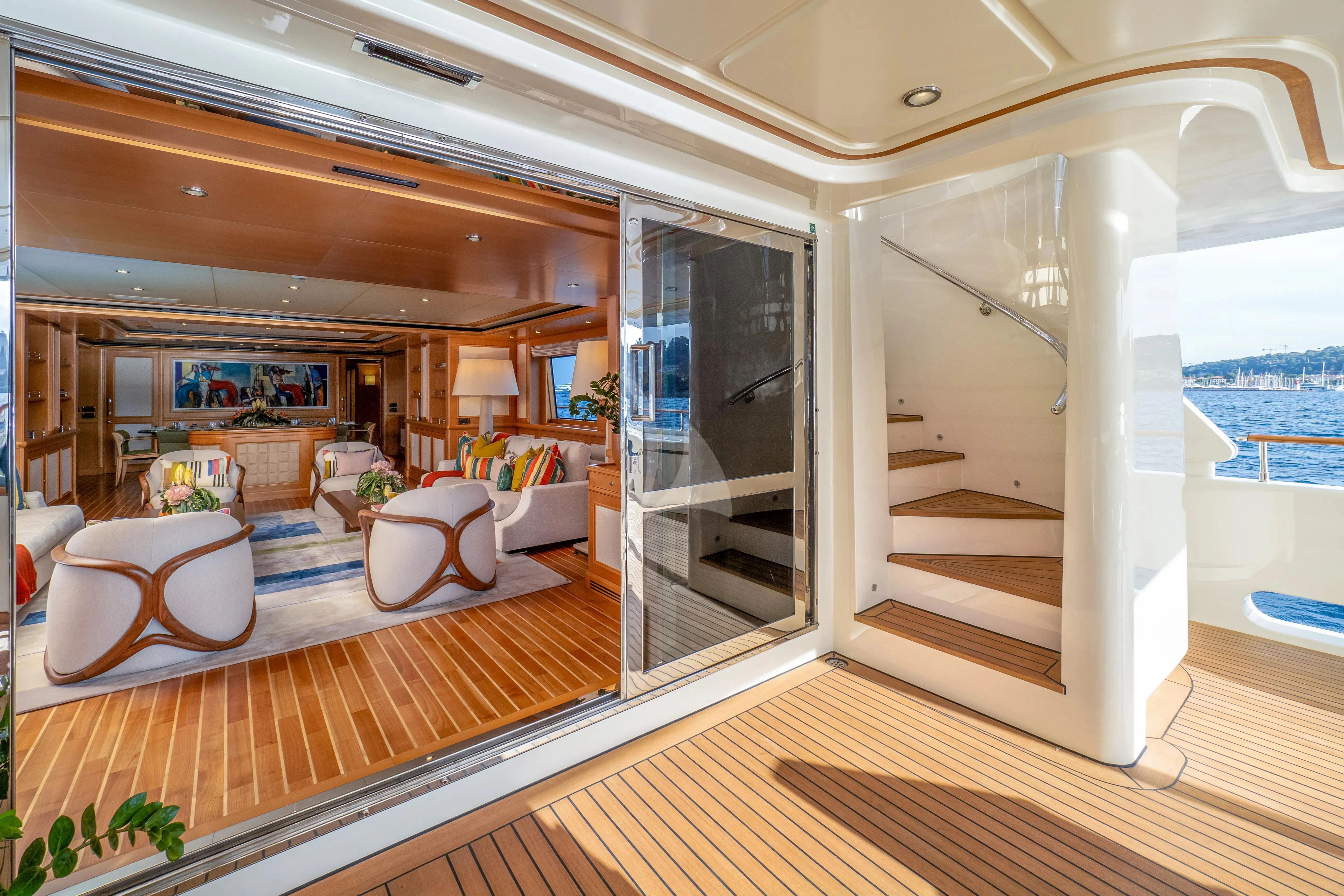 a large living room with a large open door aboard HANA Yacht for Charter