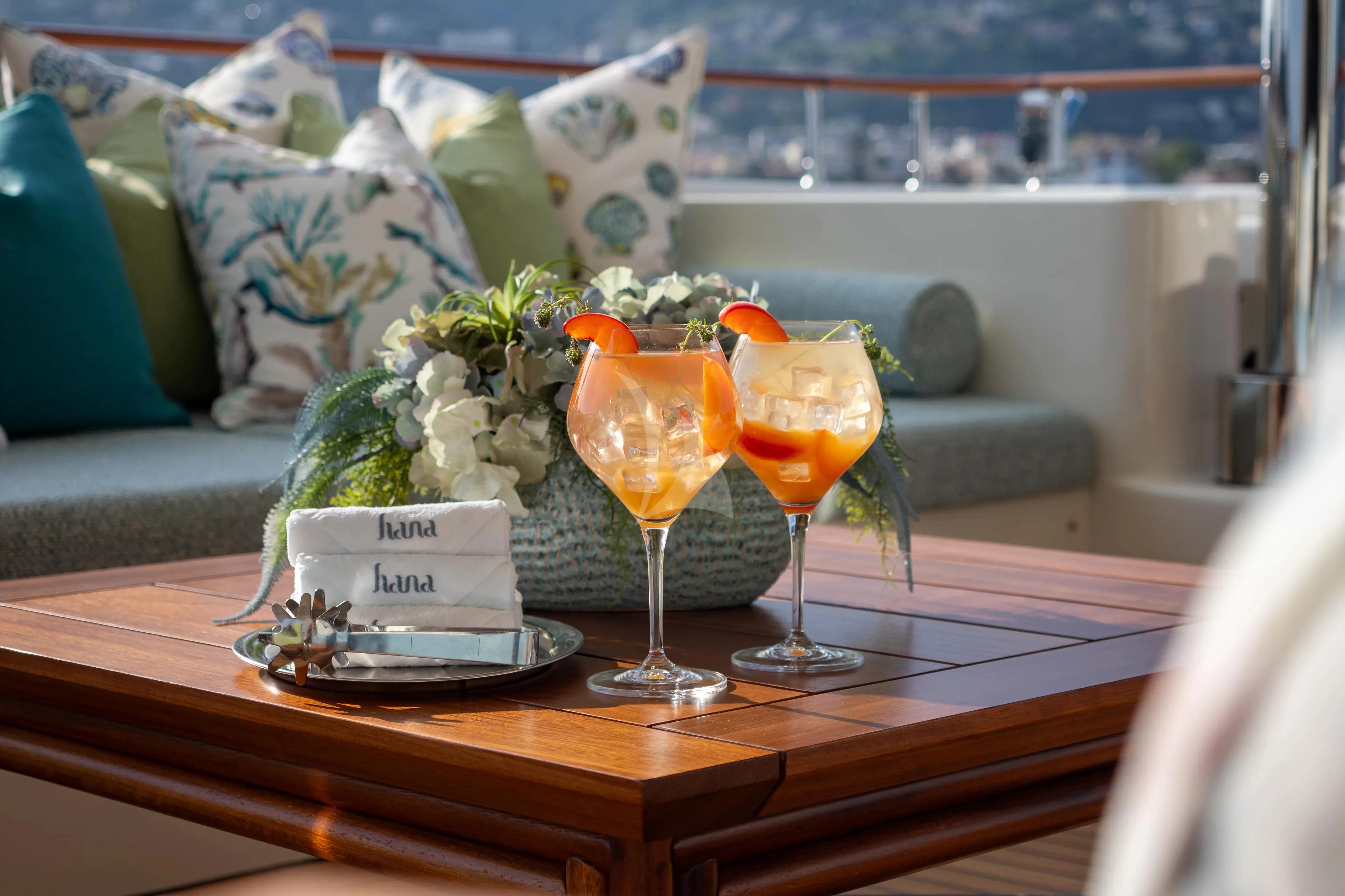 a table with drinks and food on it aboard HANA Yacht for Charter