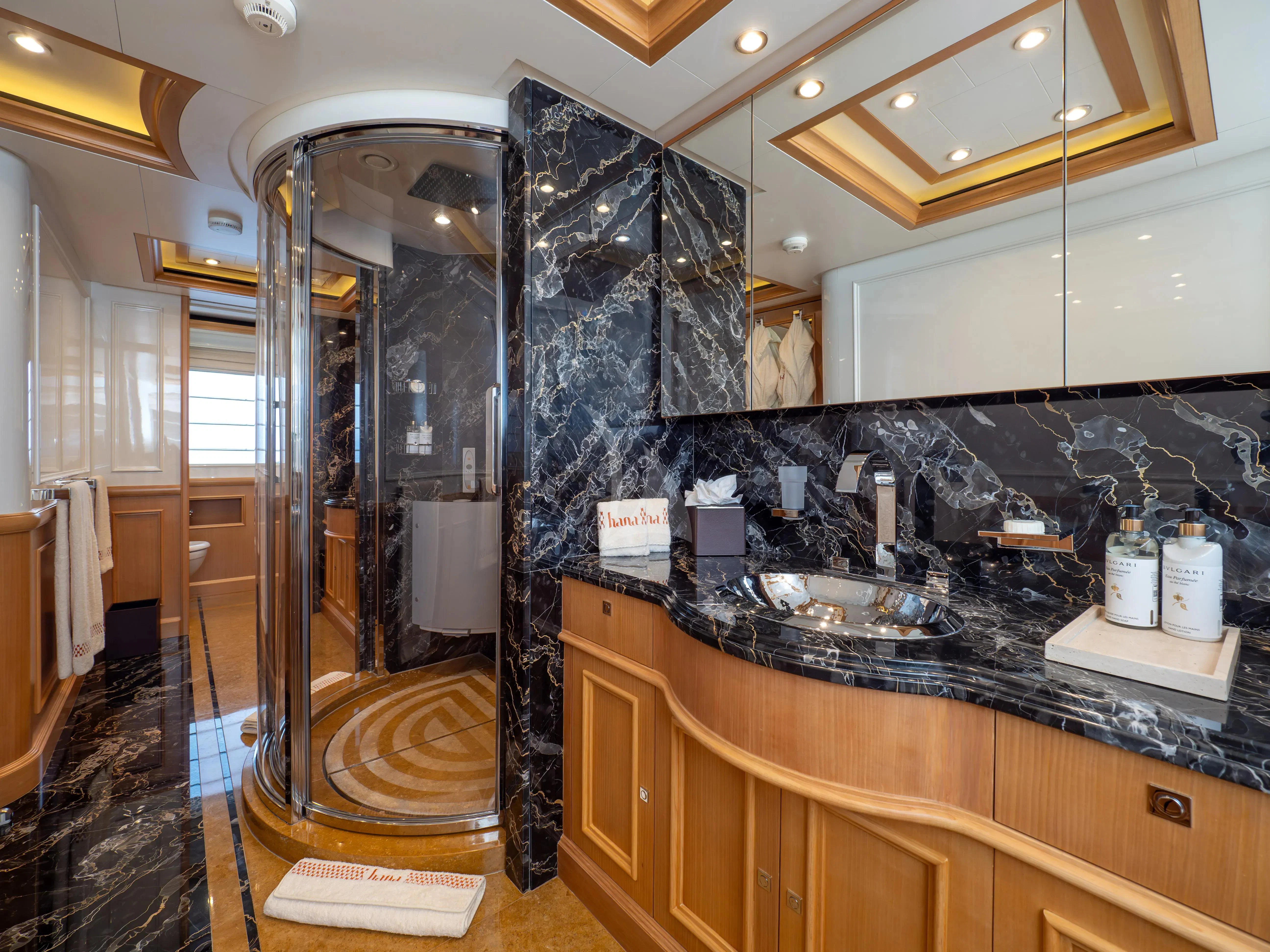 a bathroom with a large glass shower aboard HANA Yacht for Charter