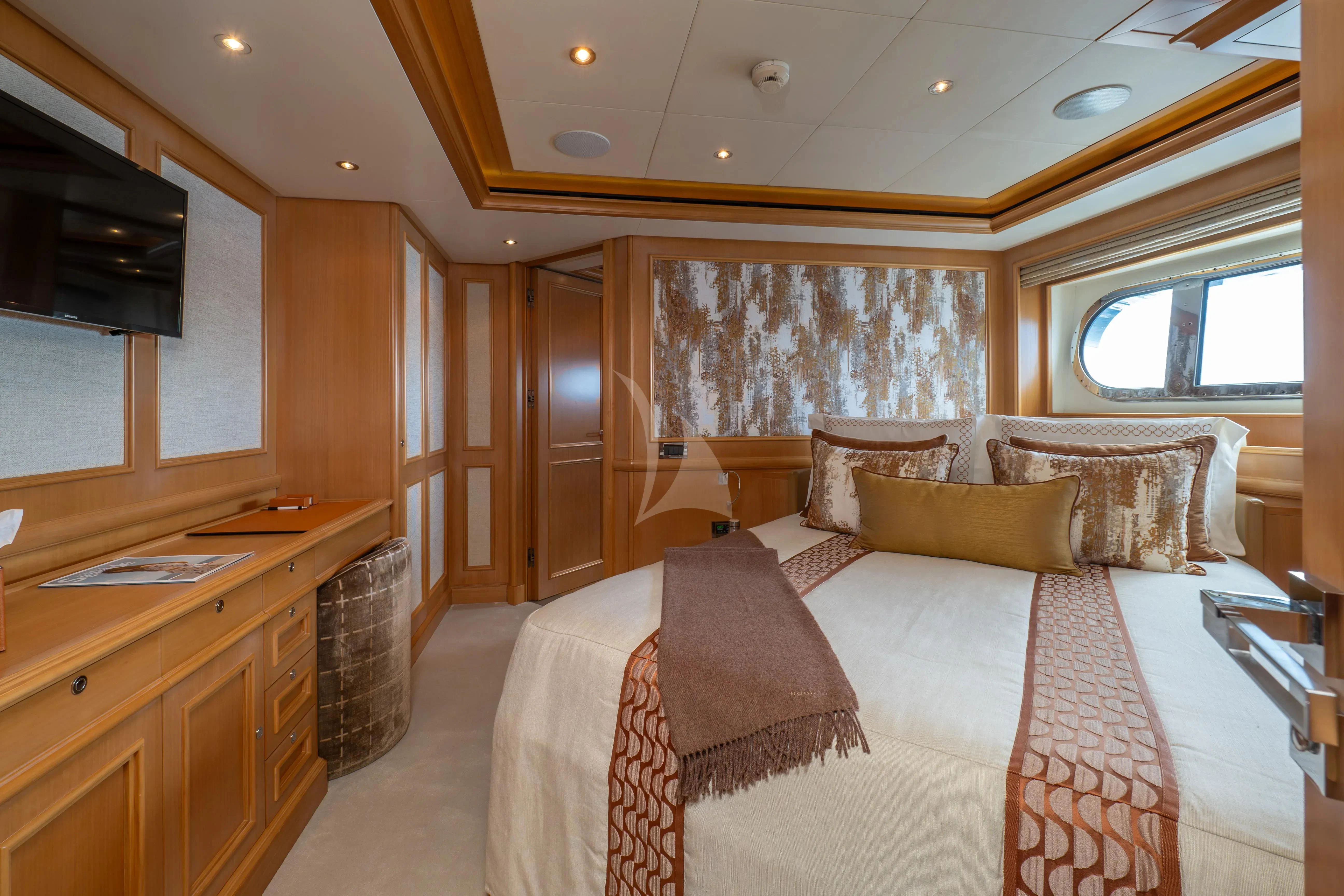a bedroom with a bed and a desk aboard HANA Yacht for Charter