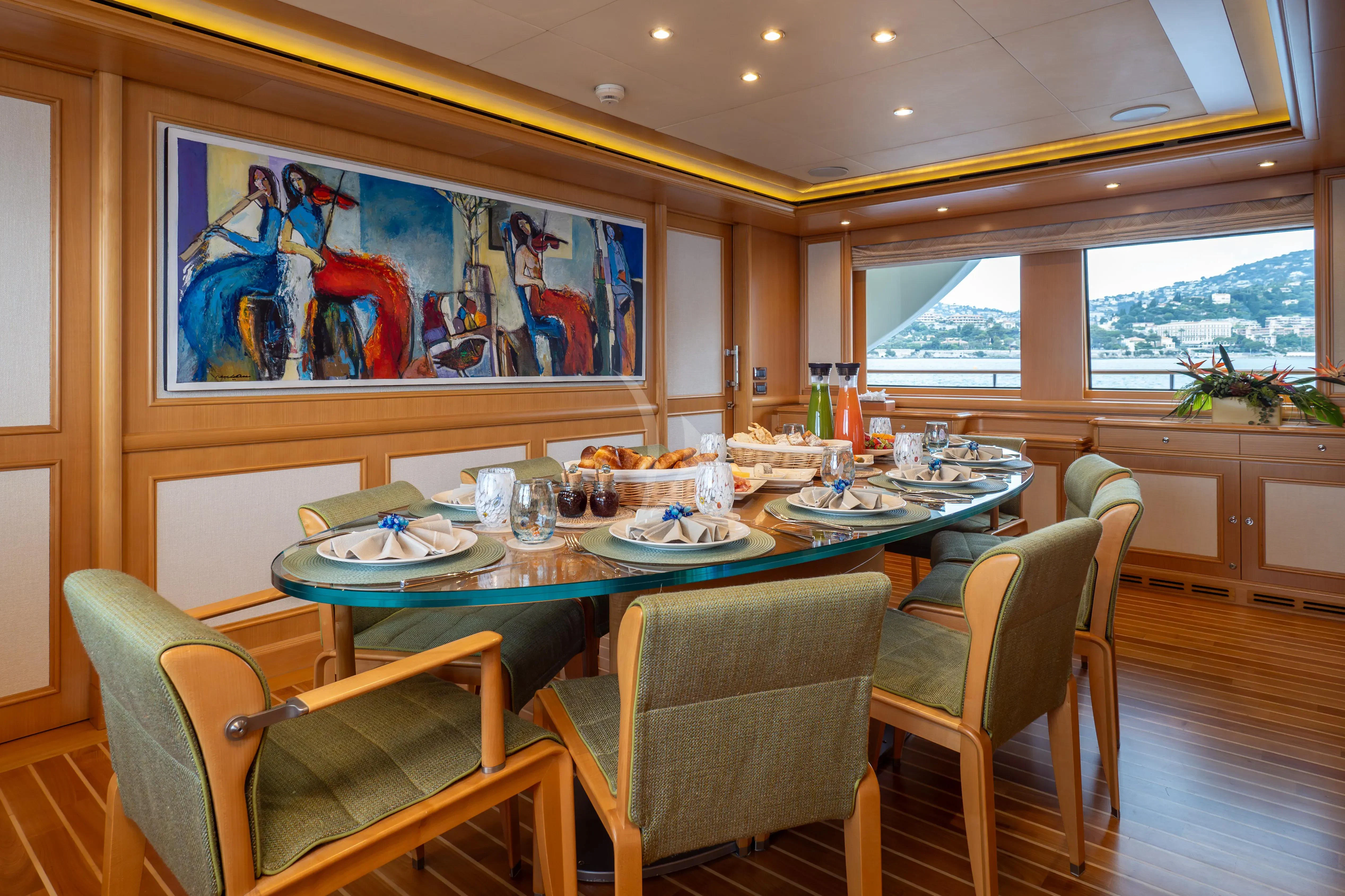 a dining table with a view of the ocean aboard HANA Yacht for Charter