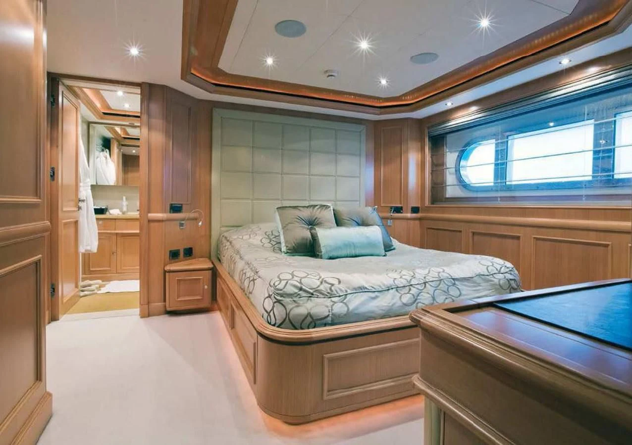 a bedroom with a bed and a desk aboard HANA Yacht for Charter
