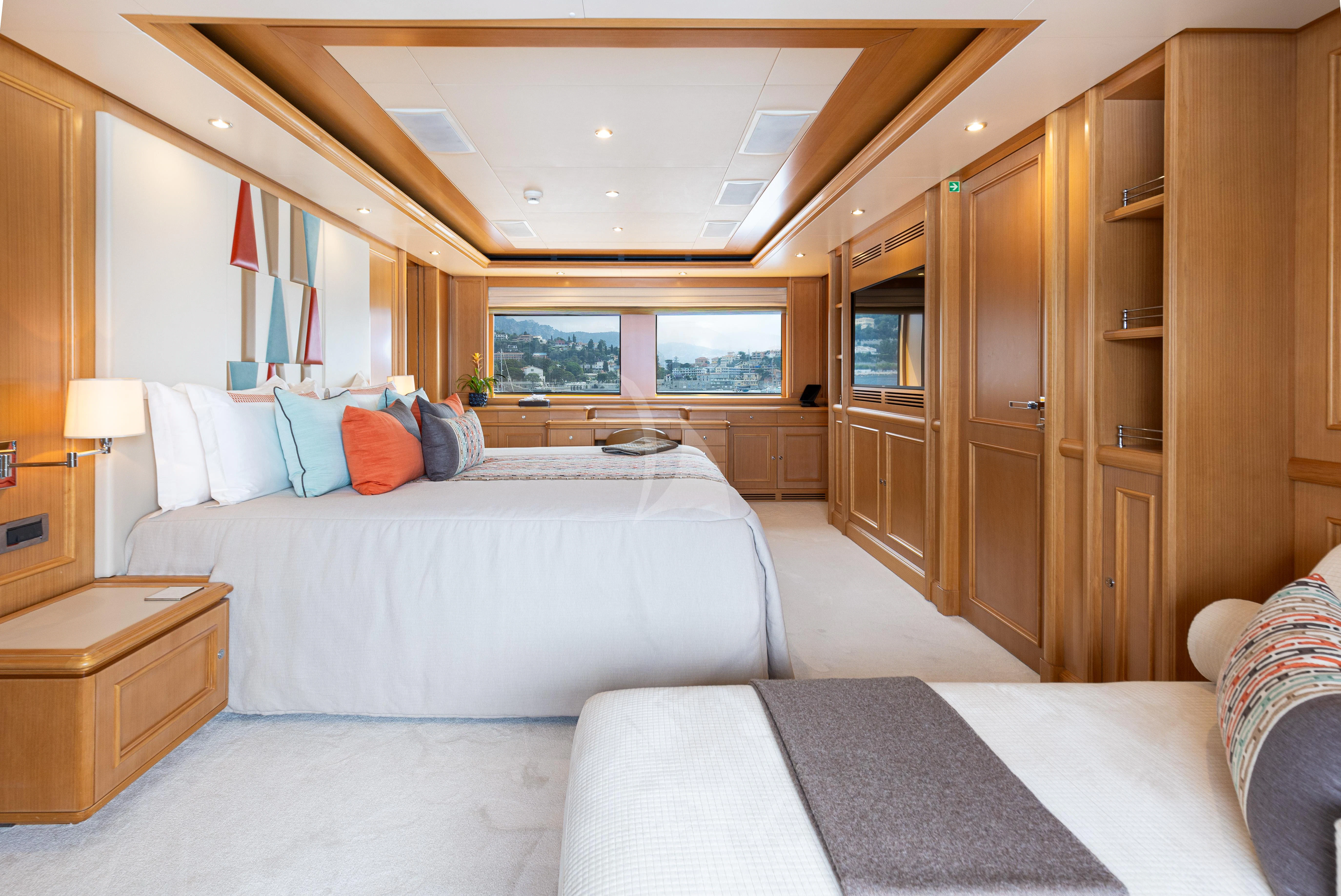 a room with a bed and a closet aboard HANA Yacht for Charter
