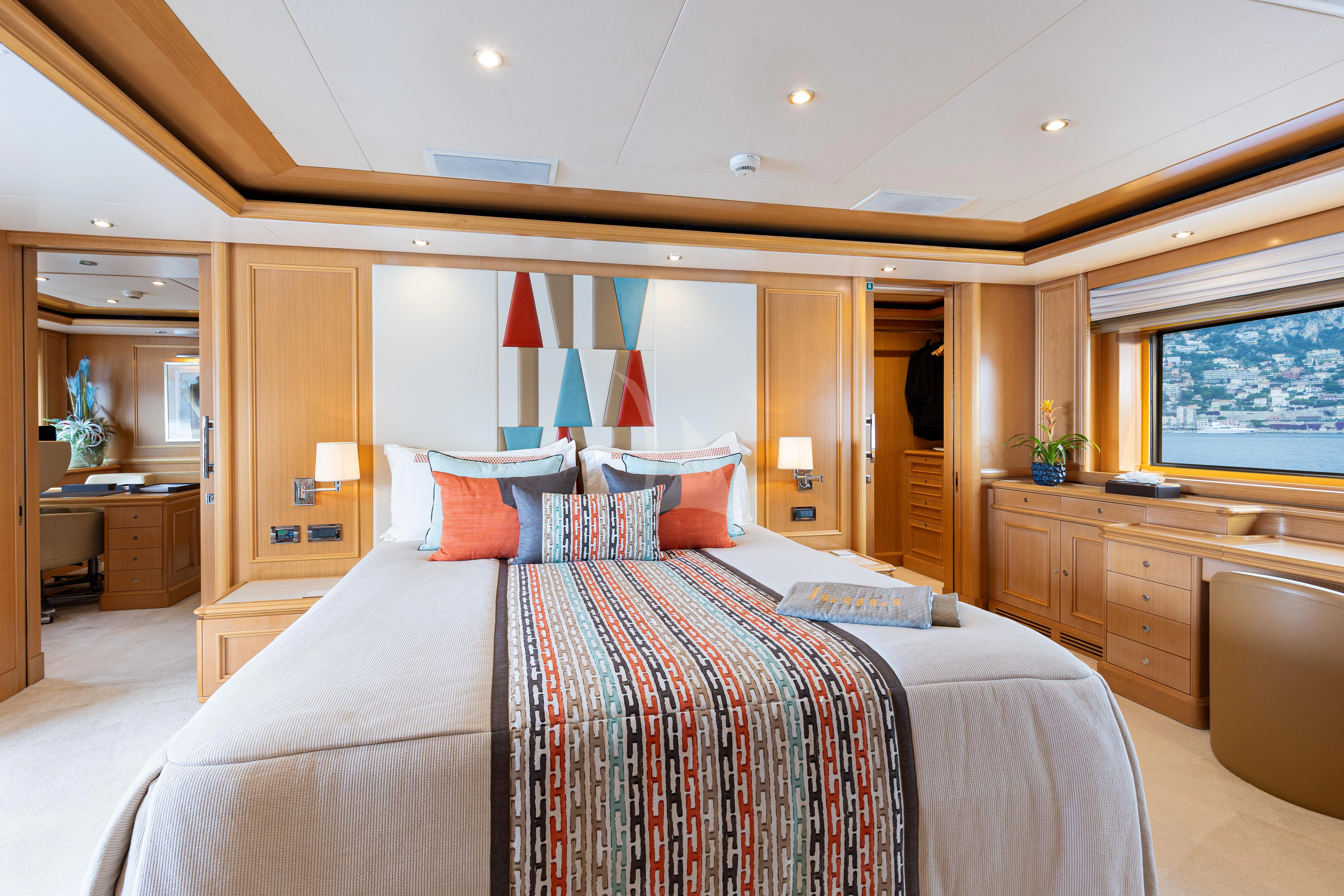 a bedroom with a bed and a desk aboard HANA Yacht for Charter