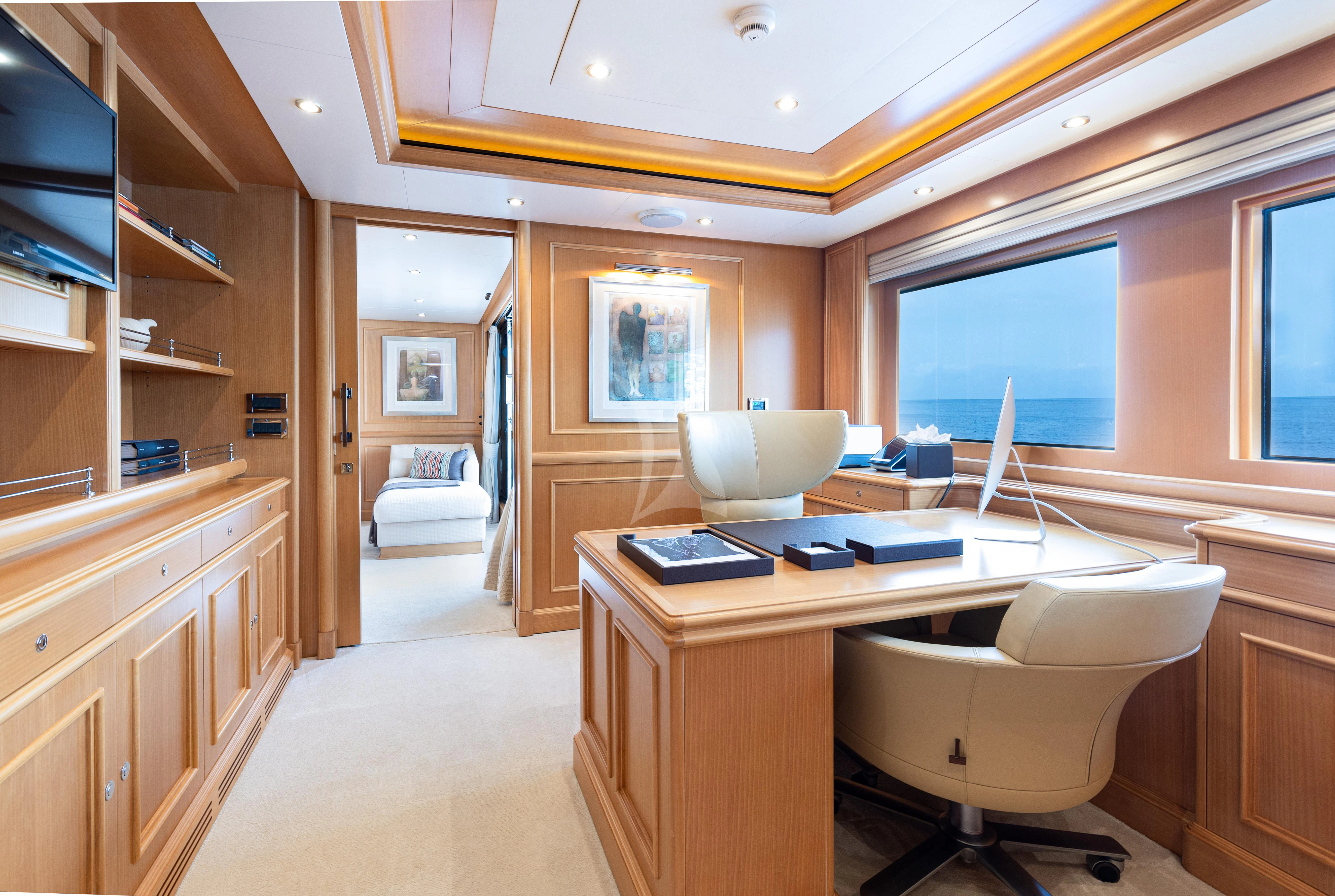 a room with a desk and a chair aboard HANA Yacht for Charter