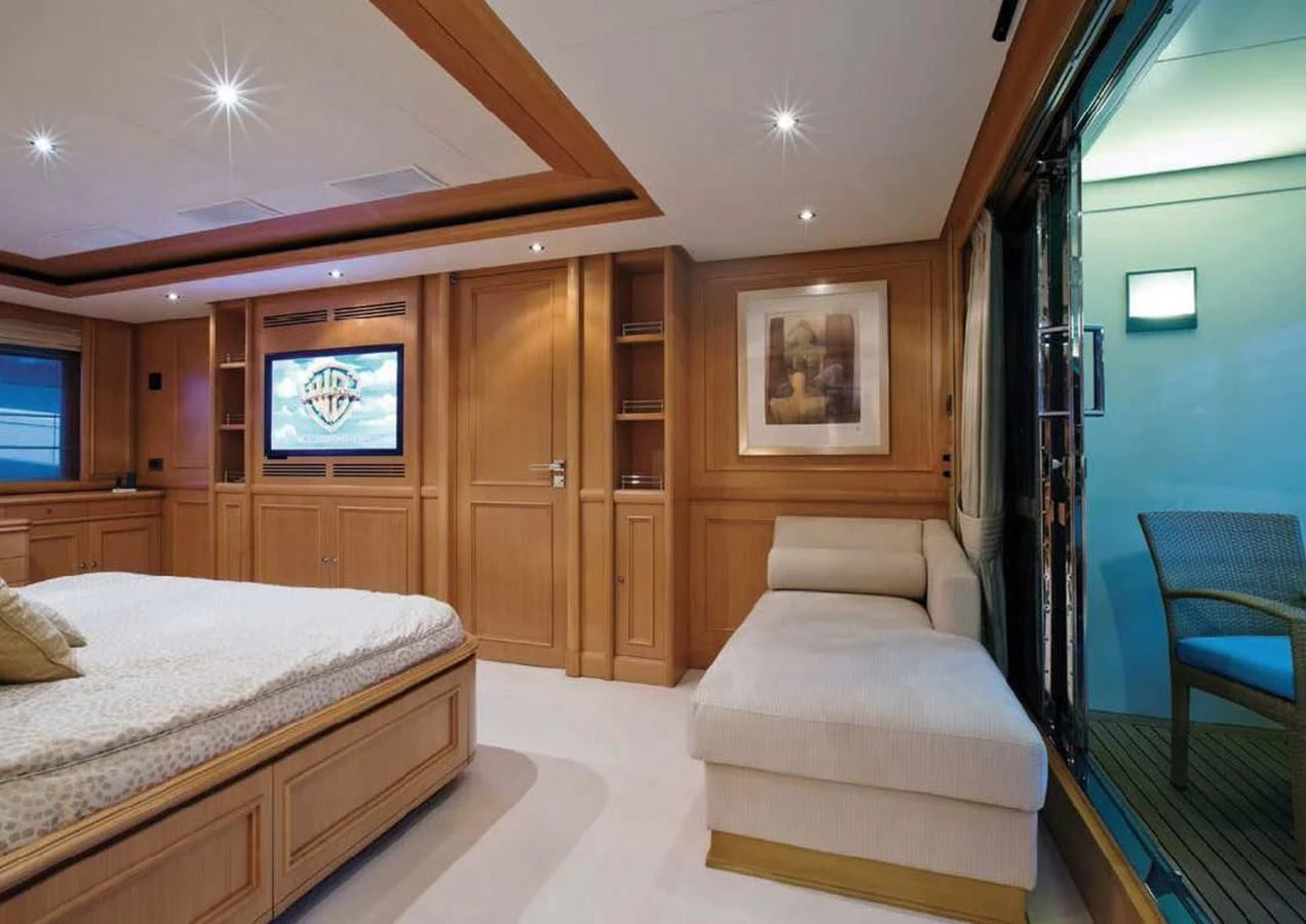 a room with a bed and a tv aboard HANA Yacht for Charter