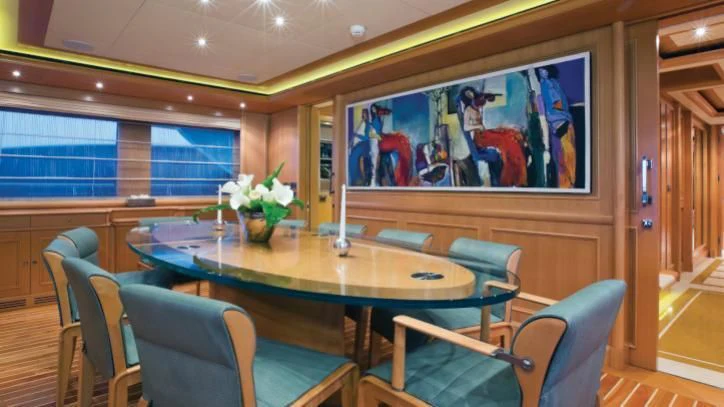 a table with chairs around it aboard HANA Yacht for Charter