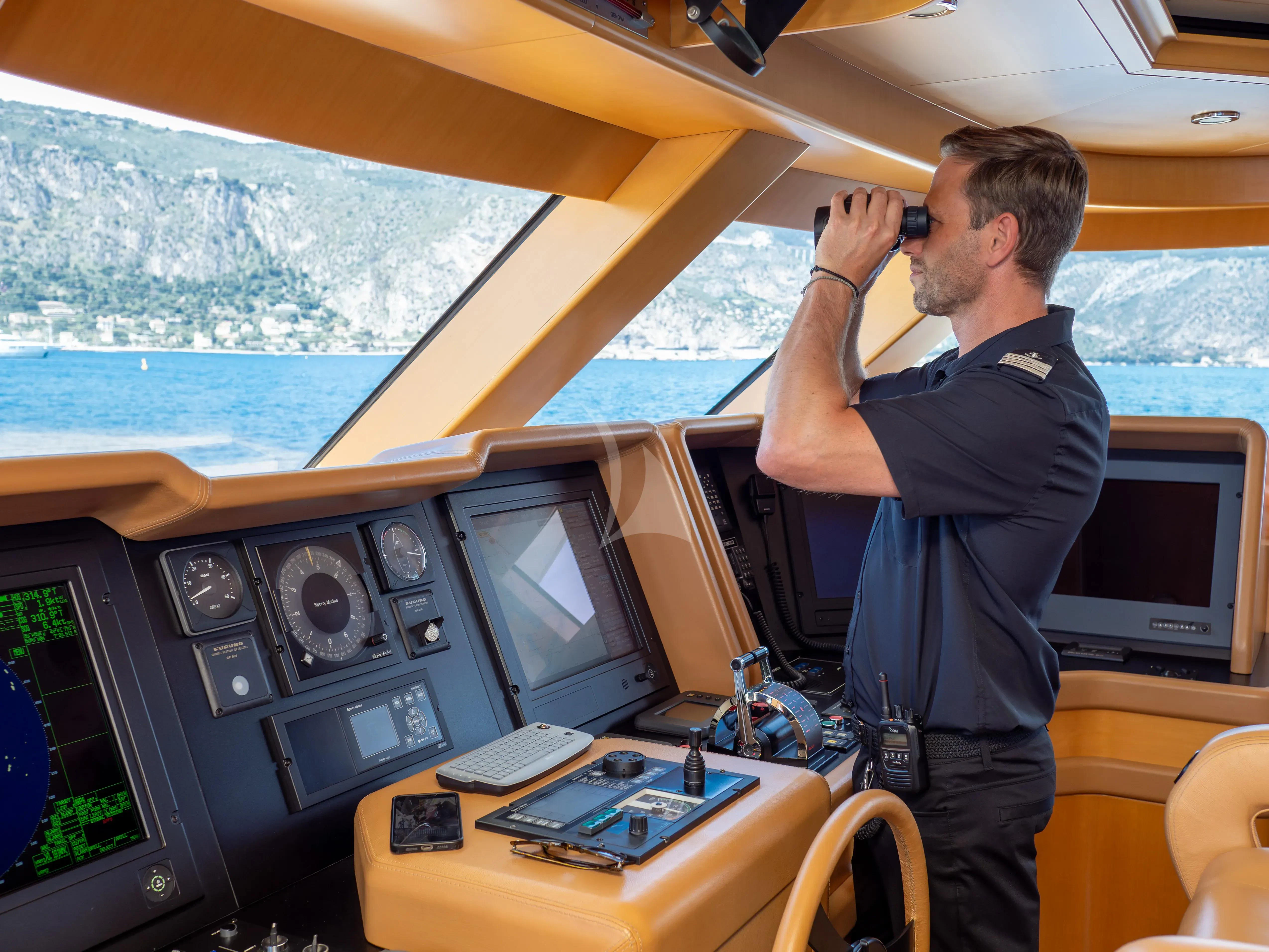 a man taking a picture of a plane aboard HANA Yacht for Charter