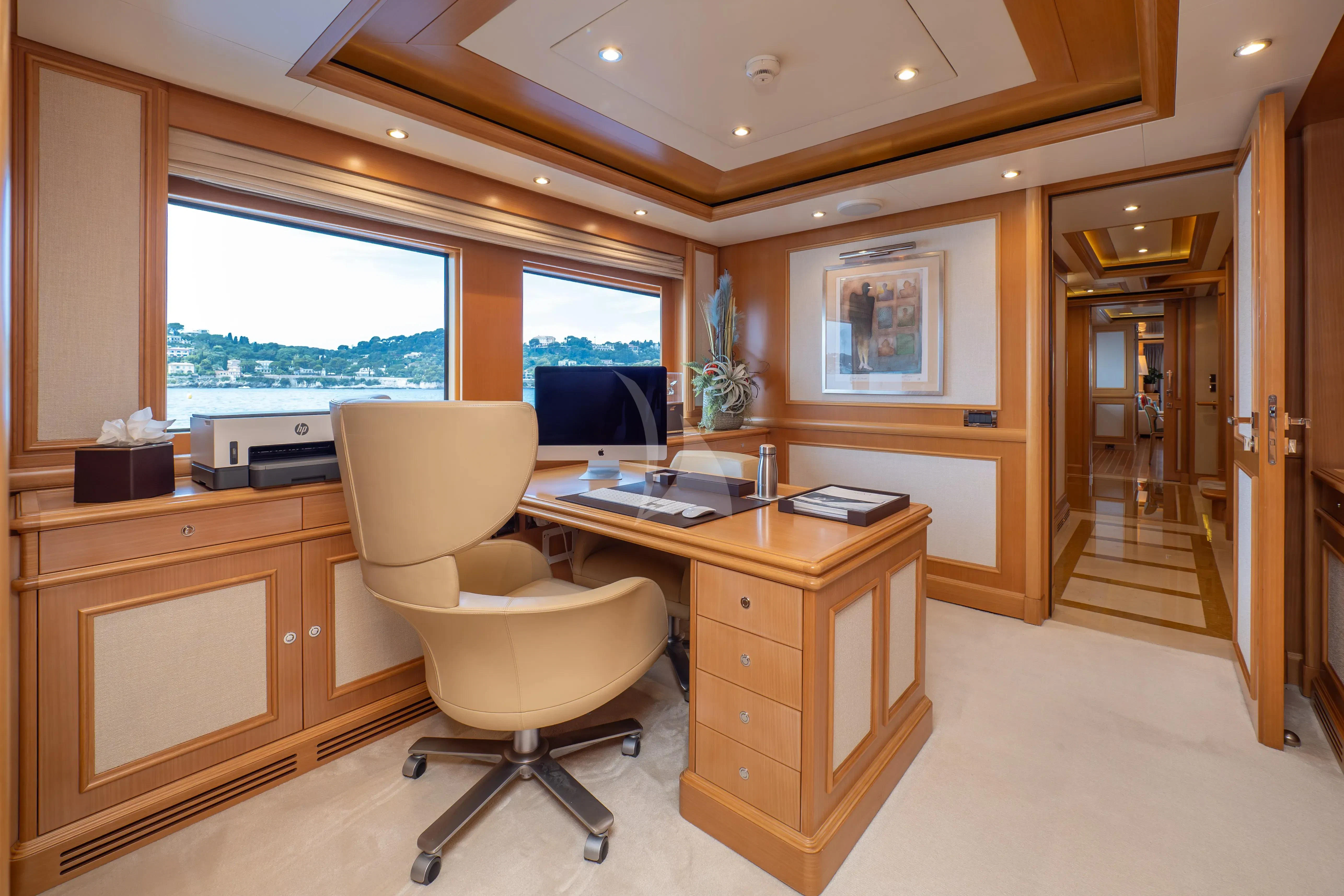 a room with a desk and a chair aboard HANA Yacht for Charter