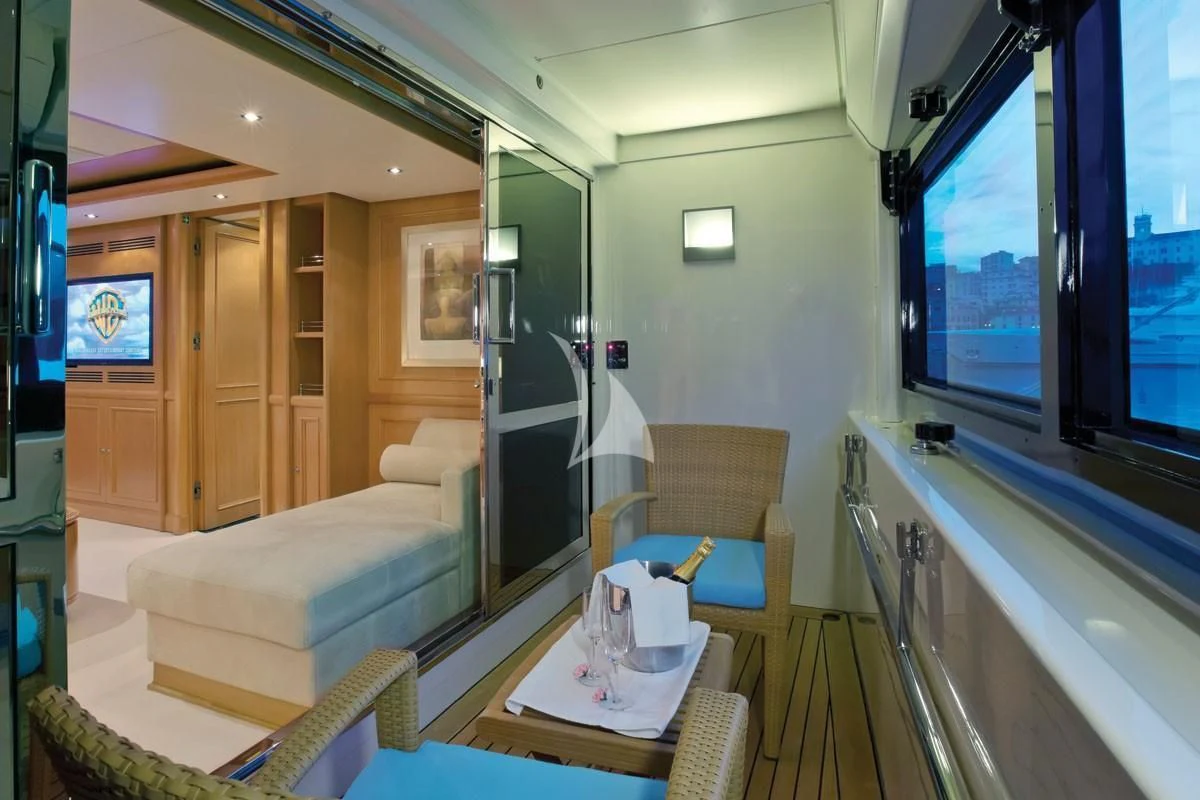 a room with a bed and a table aboard HANA Yacht for Charter