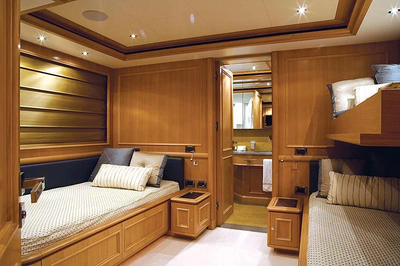 a room with a bed and a couch aboard HANA Yacht for Charter