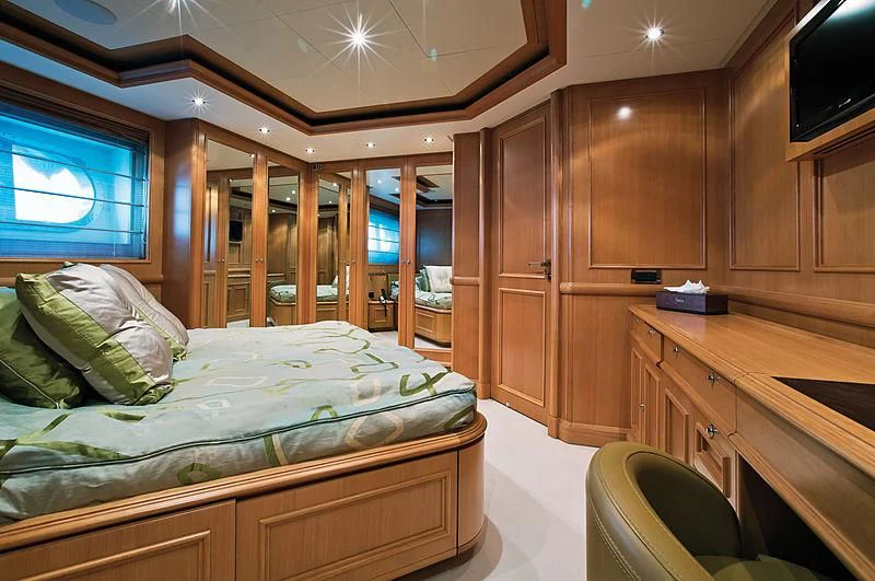 a bedroom with a bed and desk aboard HANA Yacht for Charter