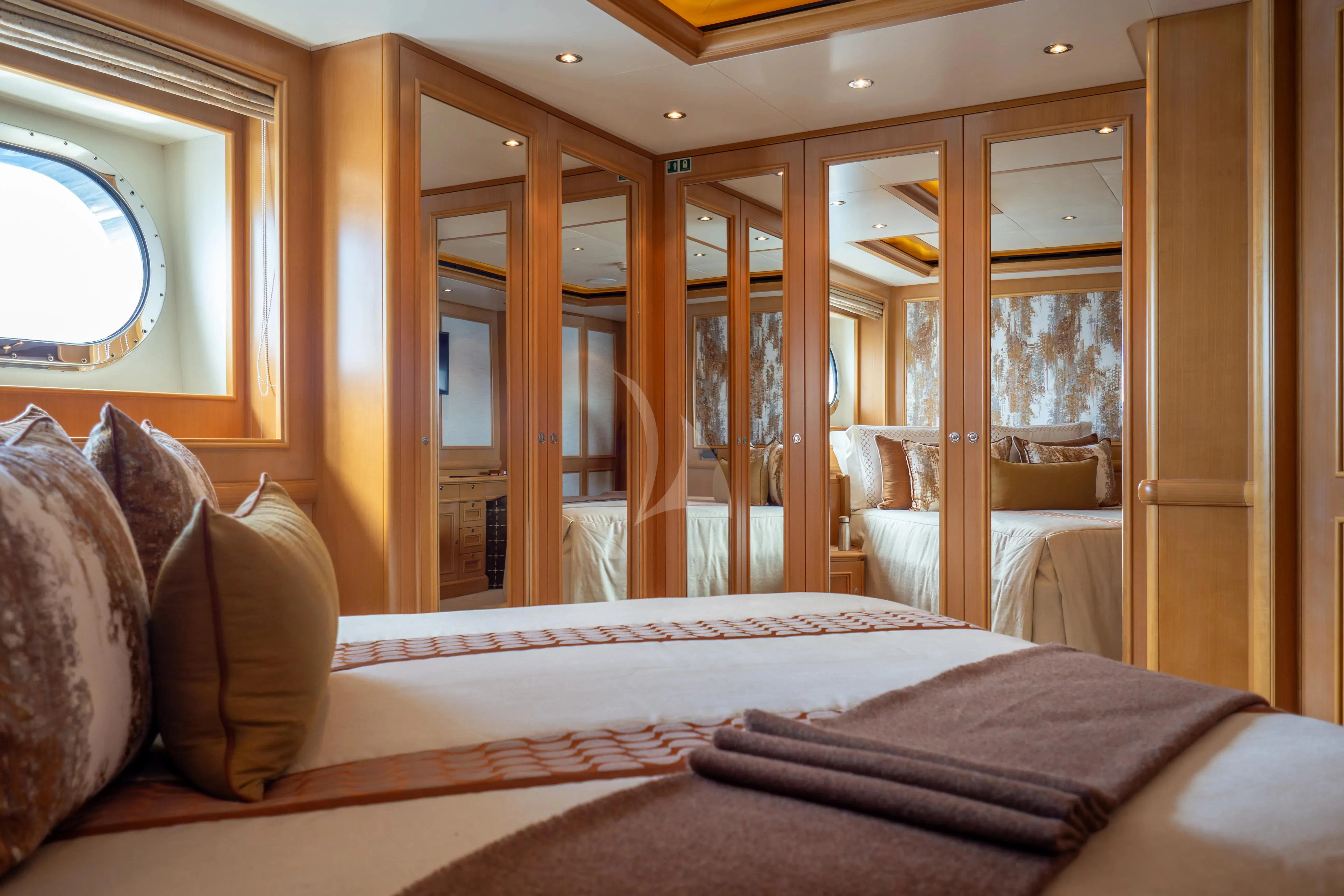 a bed with pillows and a mirror aboard HANA Yacht for Charter