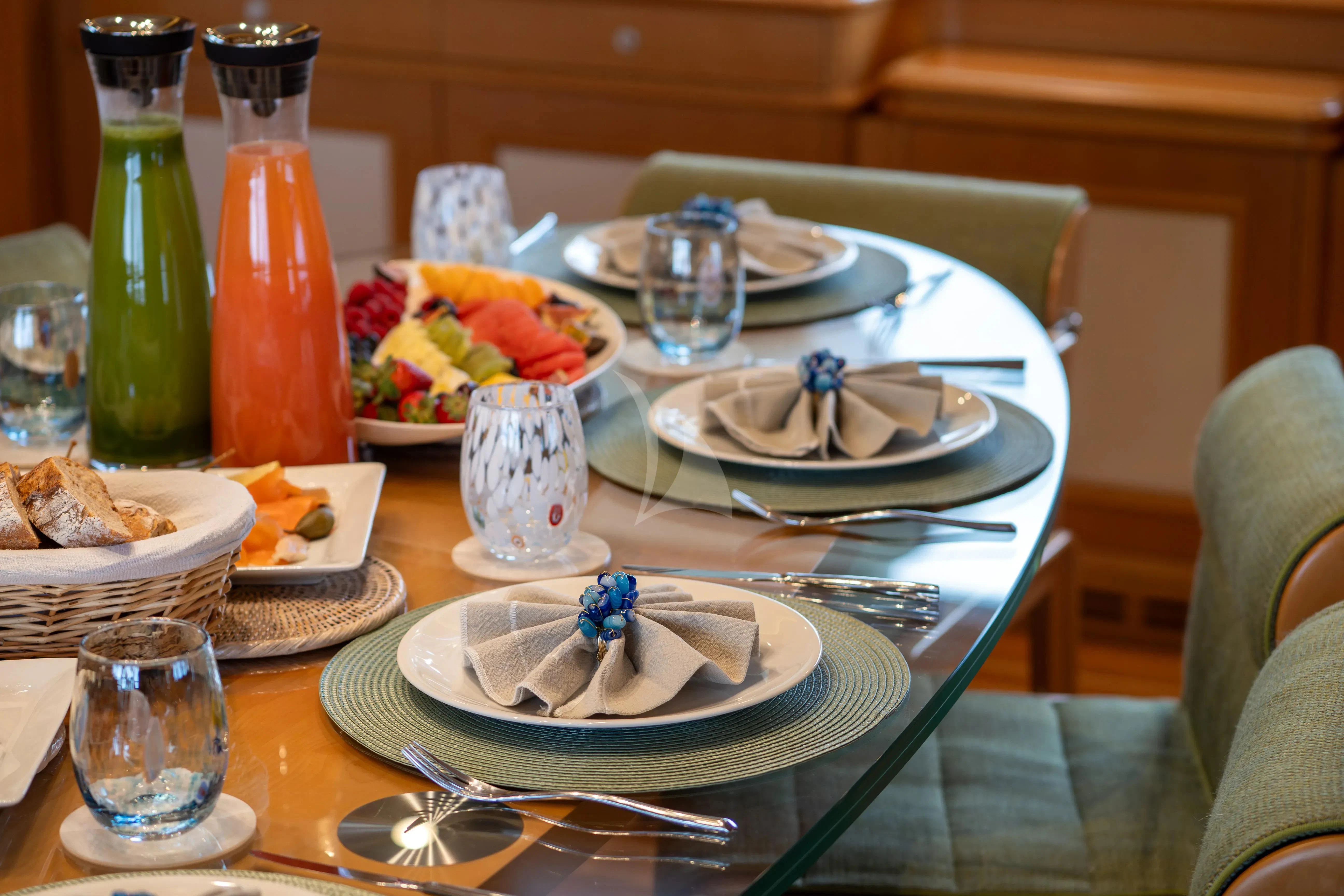 a table with food and drinks aboard HANA Yacht for Charter