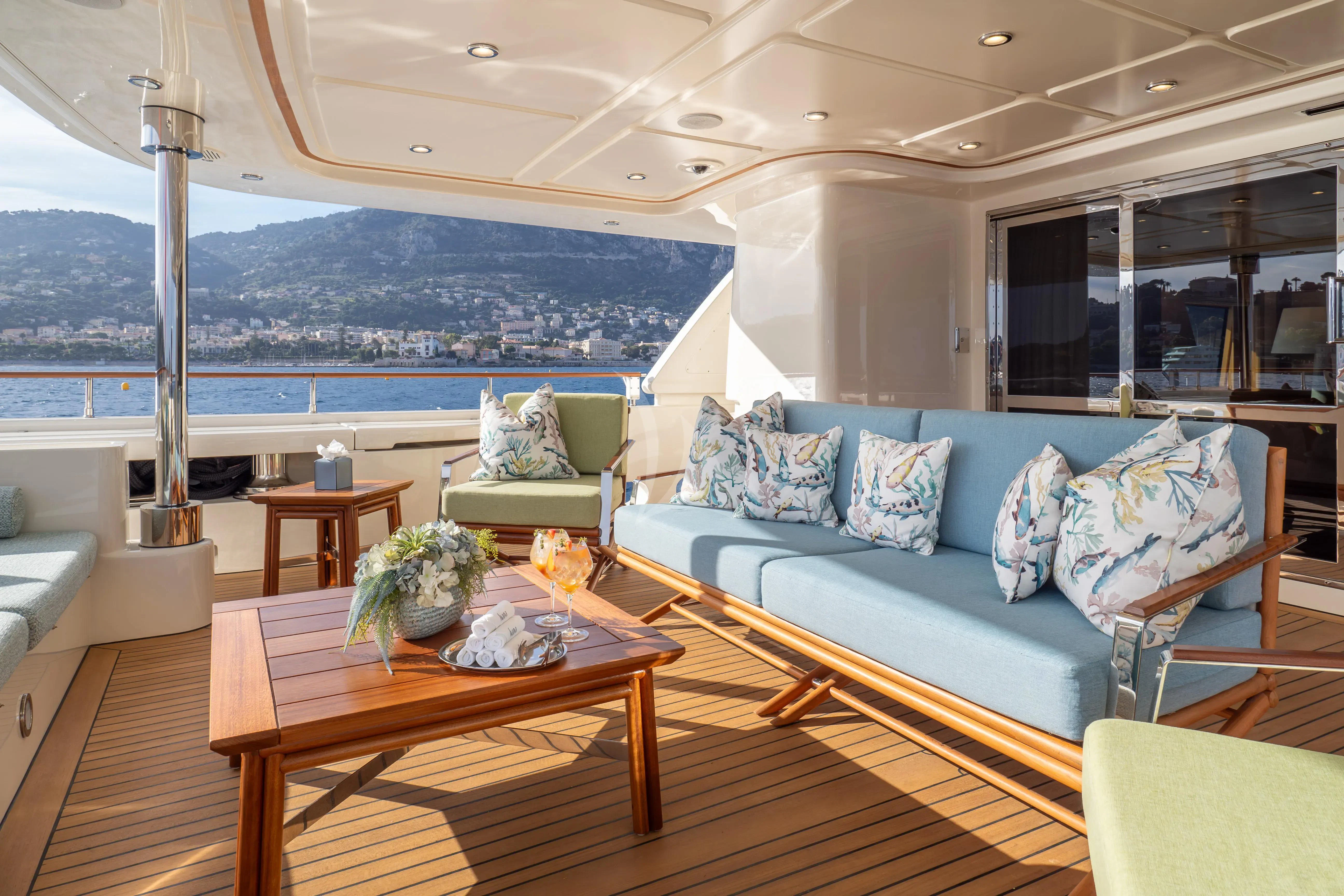 a living room with a couch and a table aboard HANA Yacht for Charter