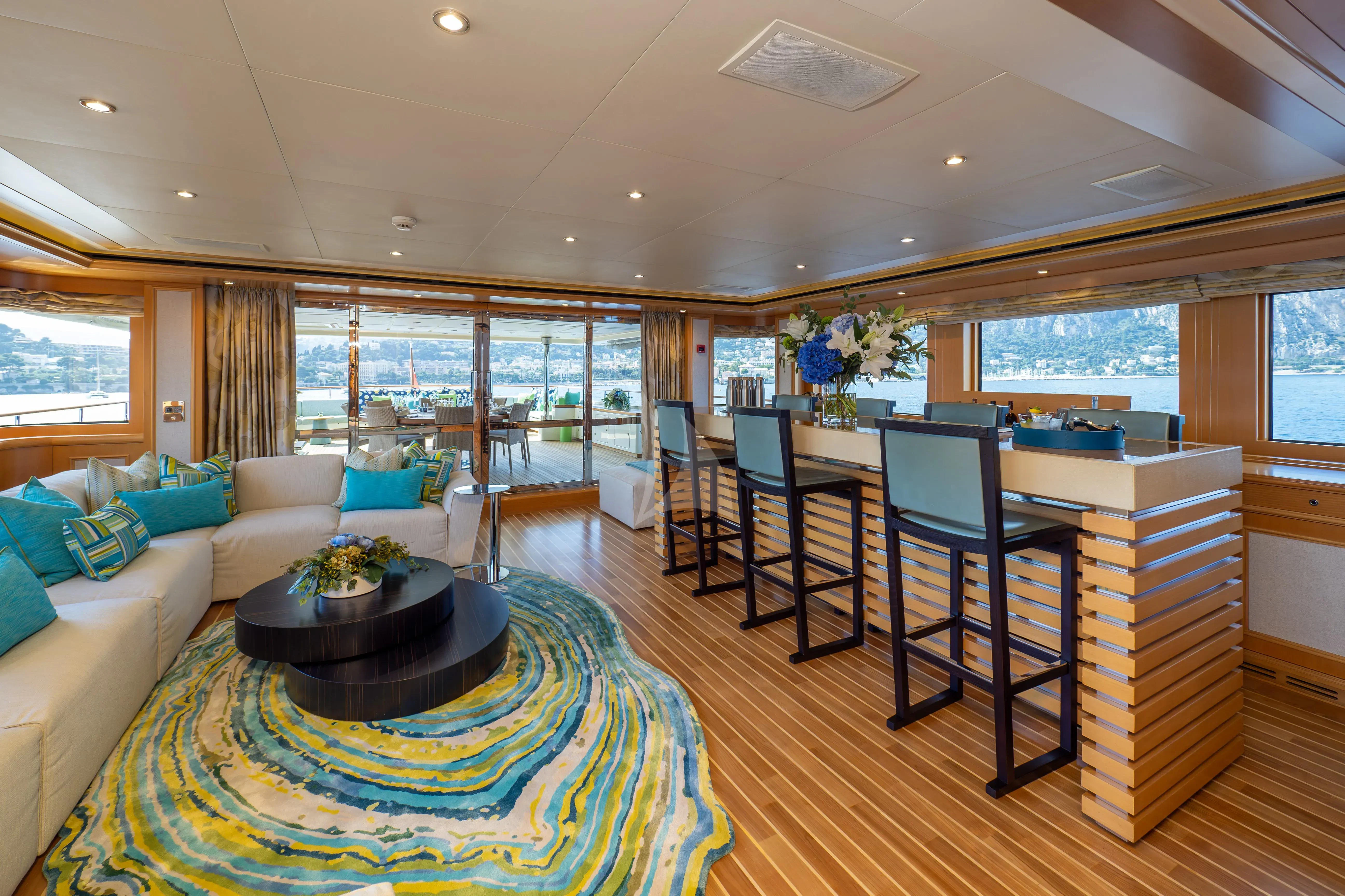a living room with a large window aboard HANA Yacht for Charter