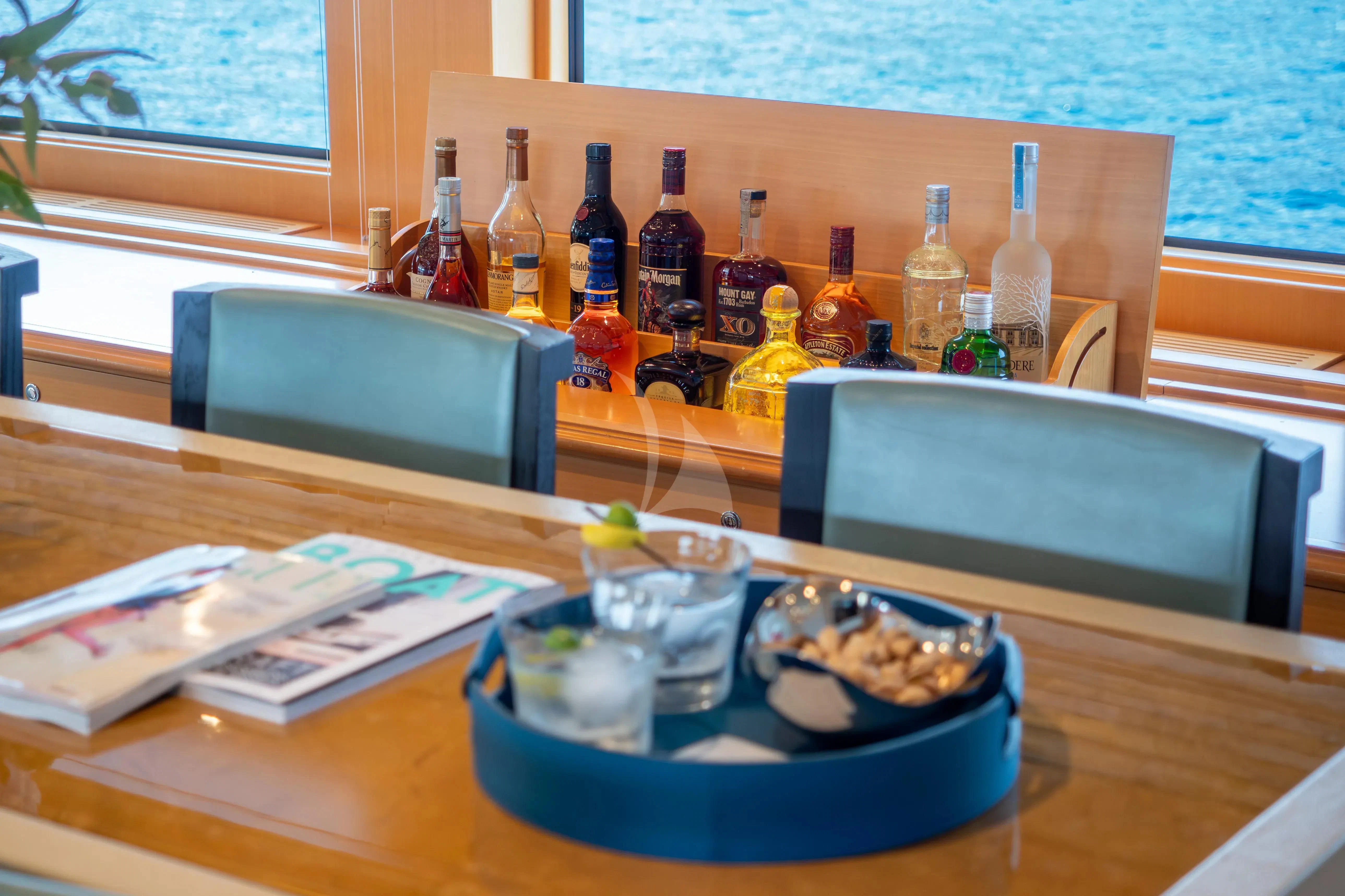 a table with food and bottles aboard HANA Yacht for Charter