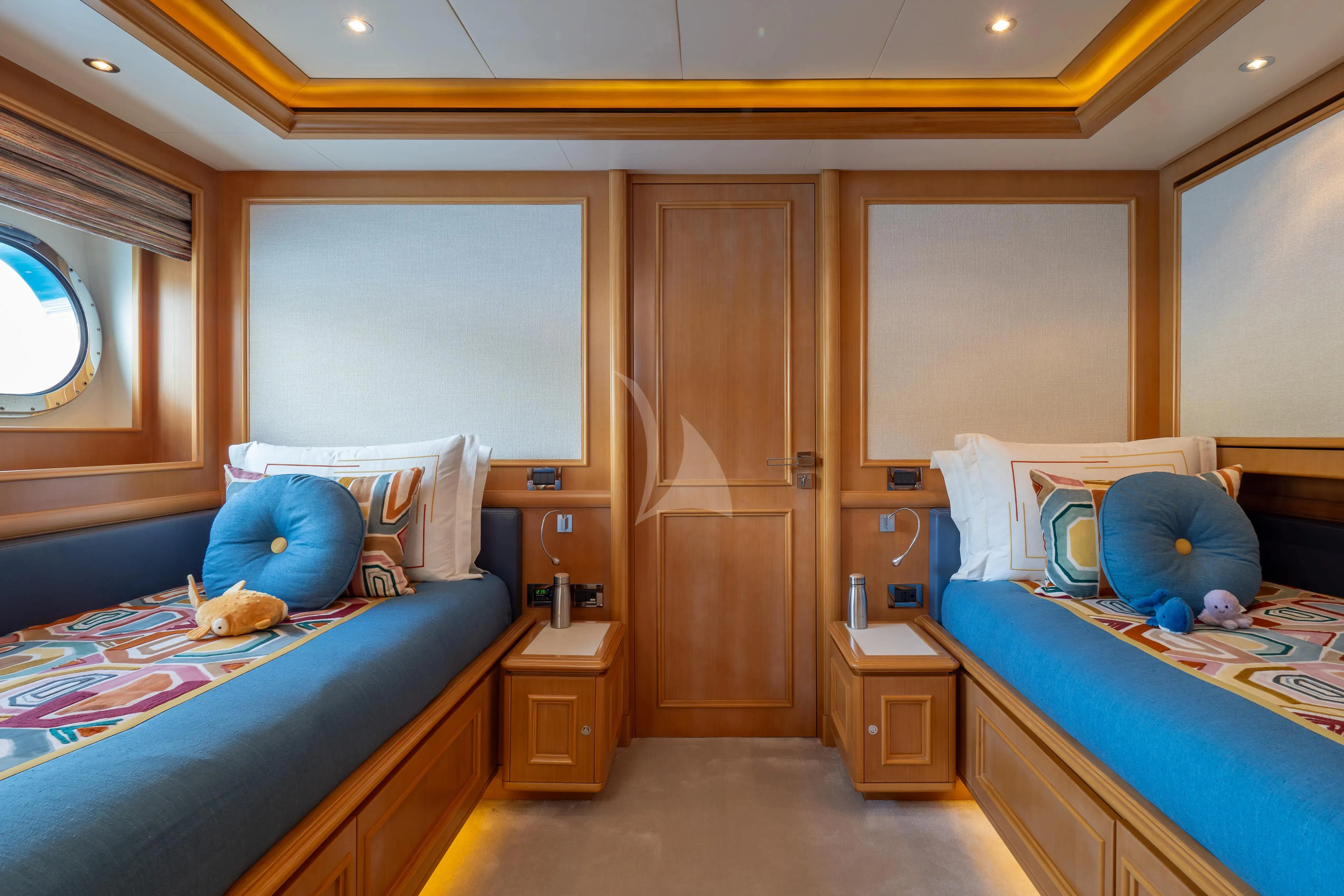 a room with a bed and a desk aboard HANA Yacht for Charter