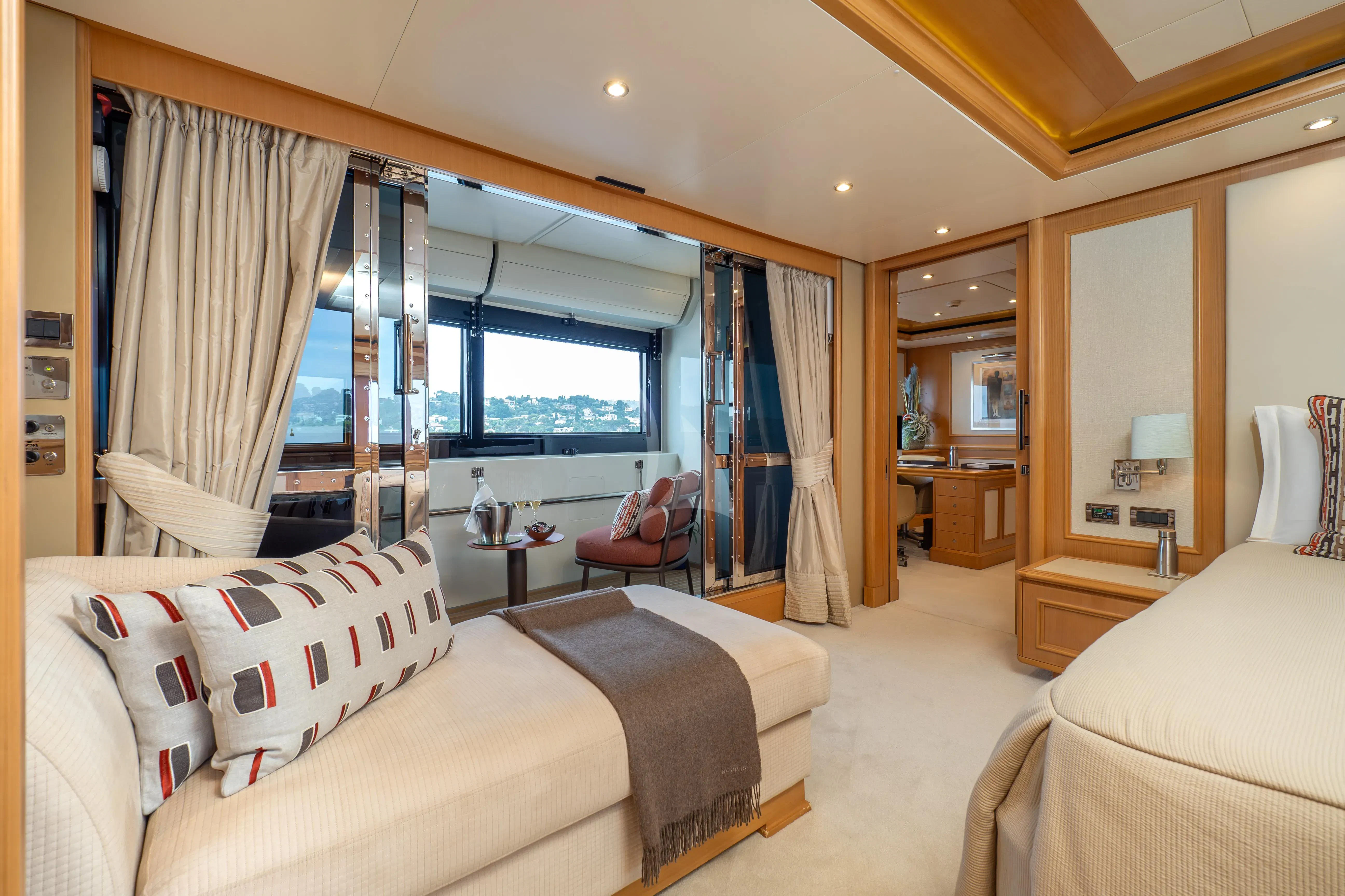 a bedroom with a bed and a window aboard HANA Yacht for Charter