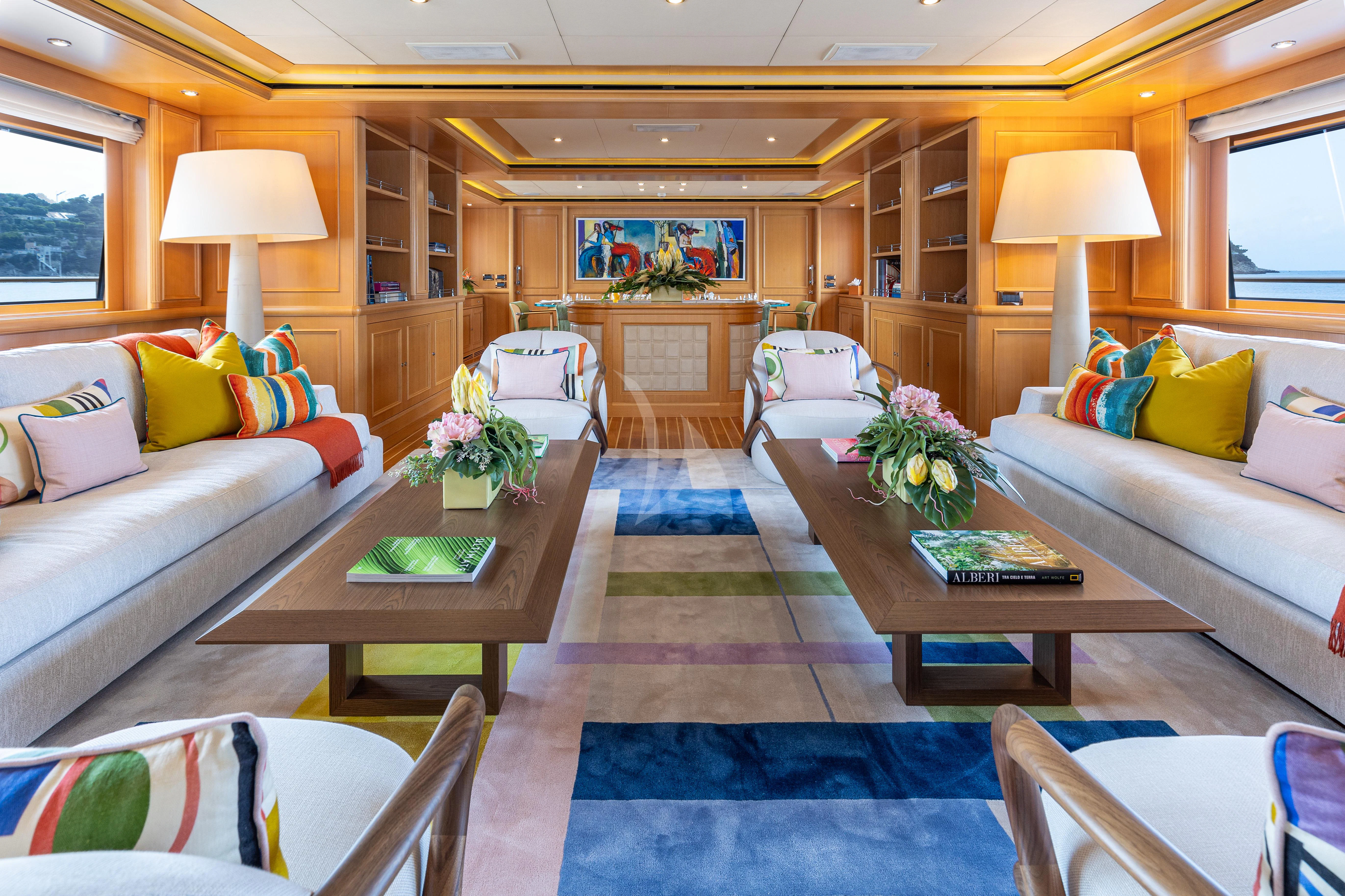 a living room with a blue rug aboard HANA Yacht for Charter