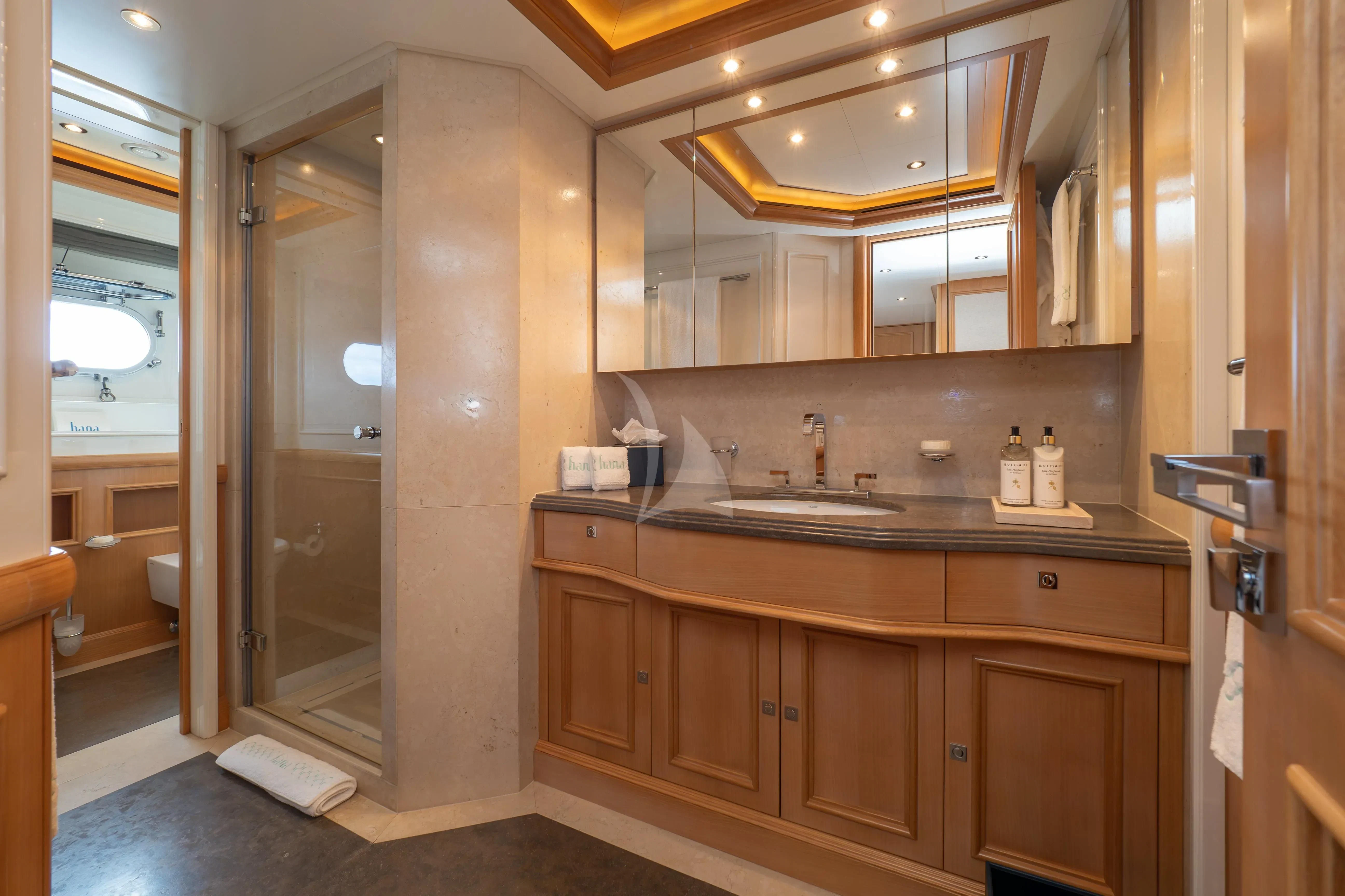 a bathroom with a sink and a shower aboard HANA Yacht for Charter